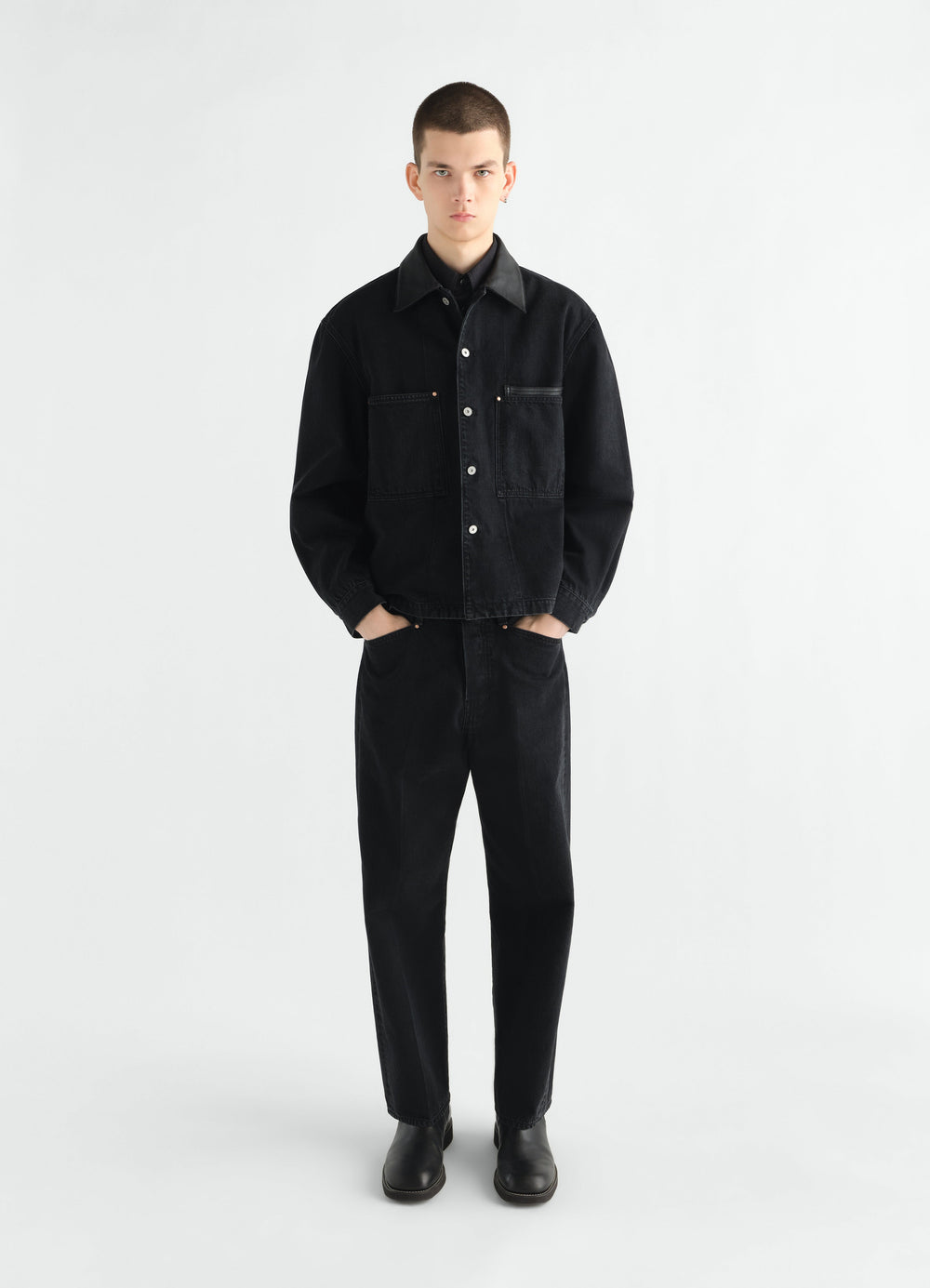 Workwear overshirt in black selvedge denim LEMAIRE worn by model front view with matching pants and black boots