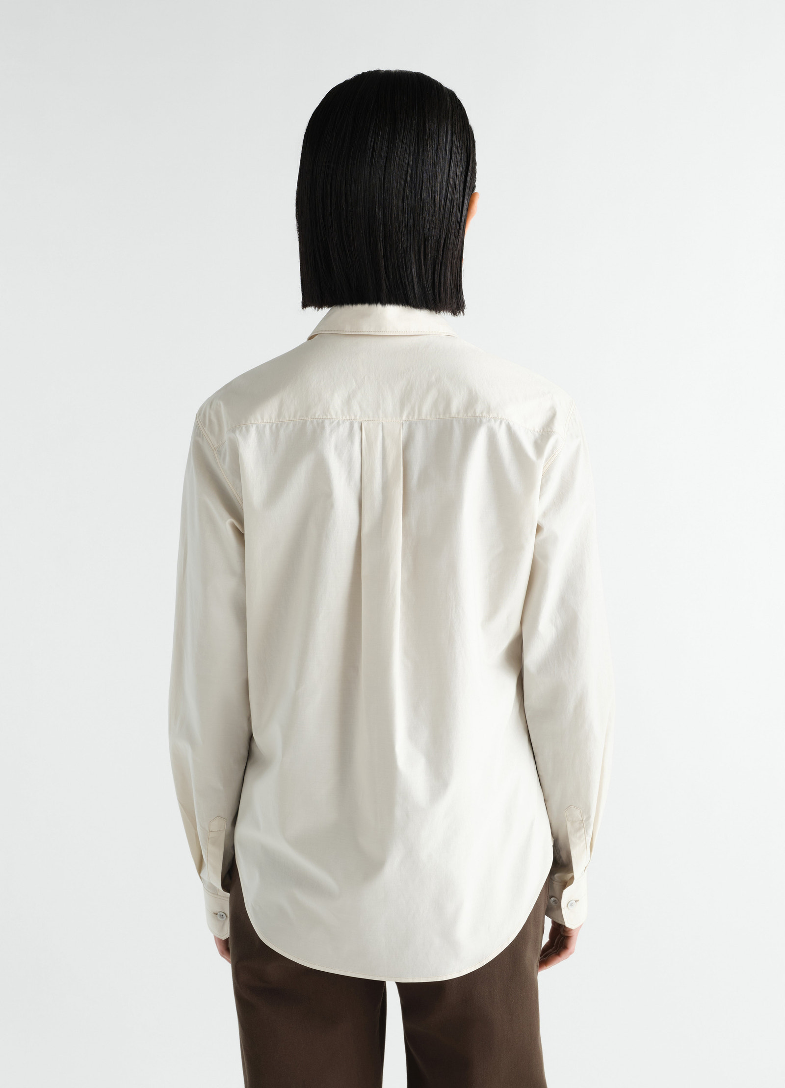 Pointed collar shirt in off-white washed cotton silk by lemaire worn by model back view