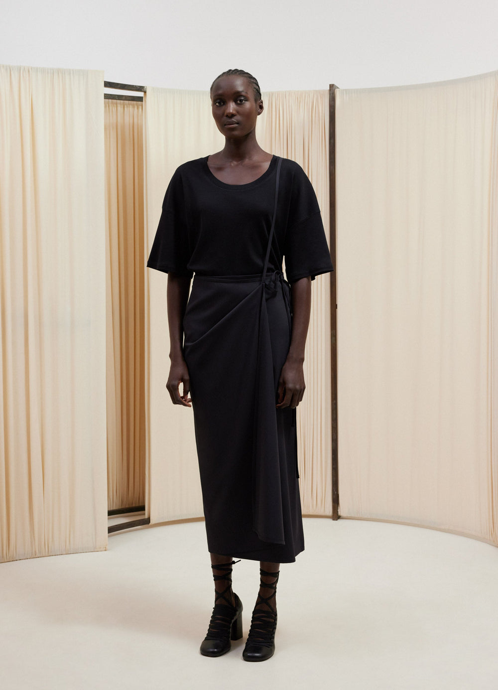 Lemaire Light Tailored Skirt in Black Virgin Wool, model shot, front view long straight wrap style