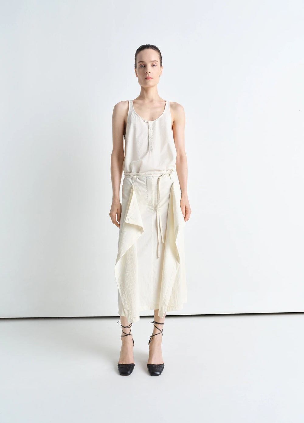 Convertible Skirt in Technical Lyocell, model shot, front view draping panel tied waist