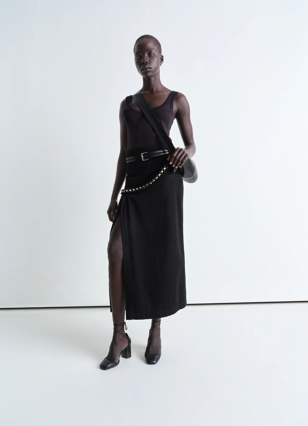 Lemaire Asymmetrical Wrap Skirt in Black Cotton Denim, model shot, front view belted waist with slit