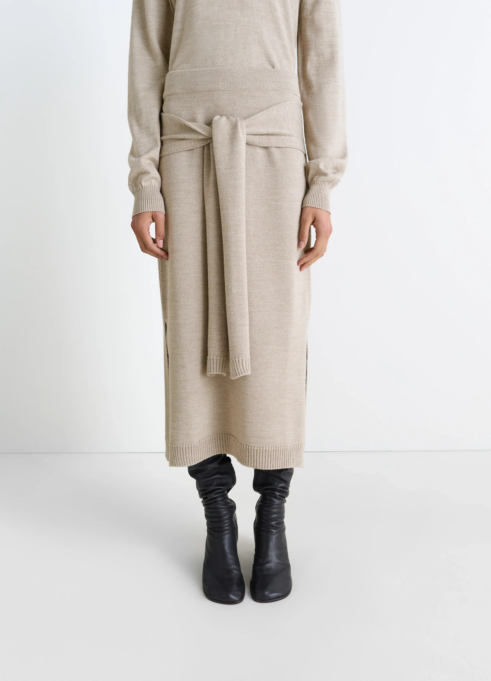 Lemaire trompe loeil skirt in beige blended merino wool, model shot, full front with boots tie panels at waist