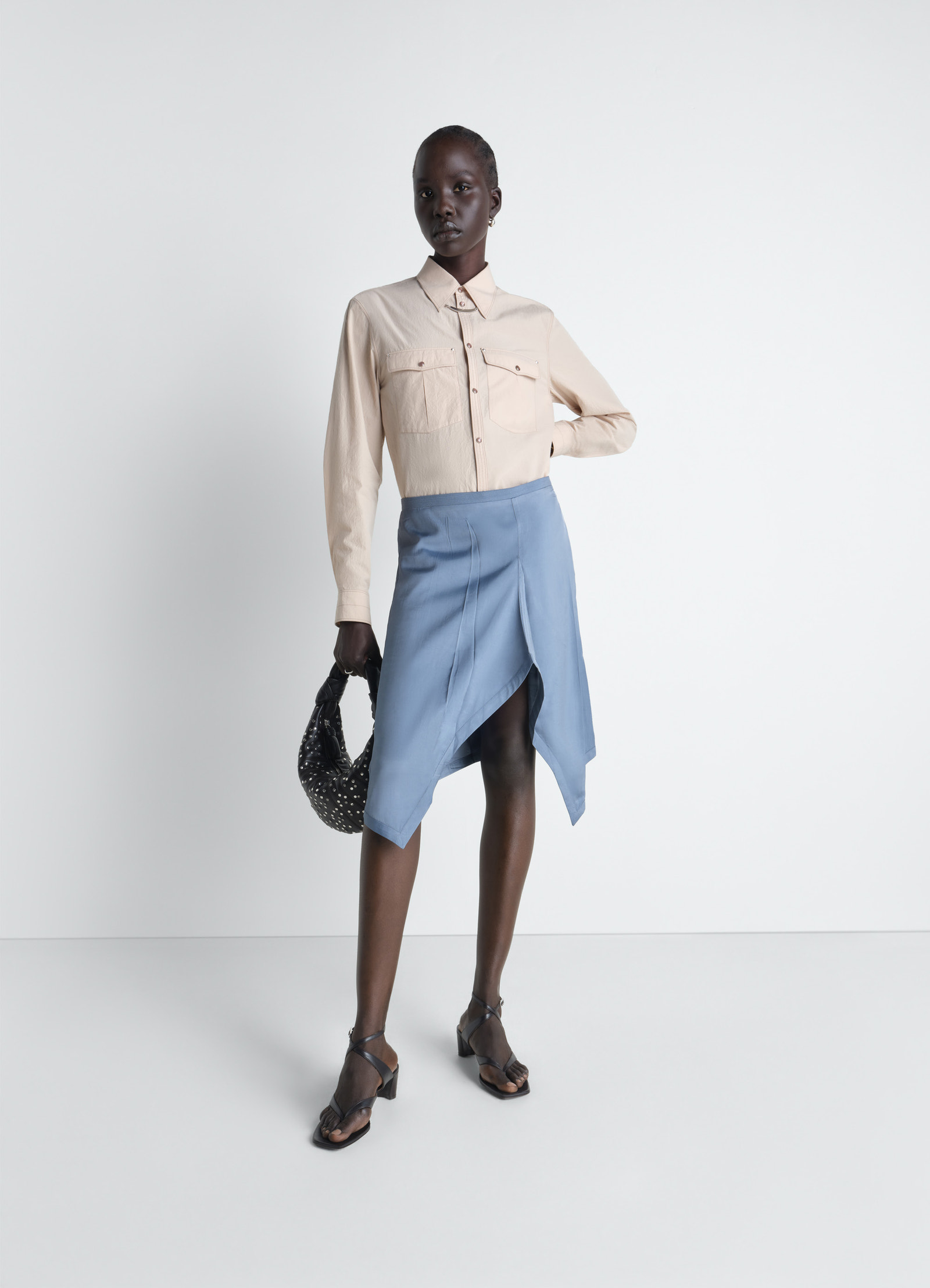 Creased foulard skirt in poly viscose twill, model shot, front view irregular pleats, fluid cut