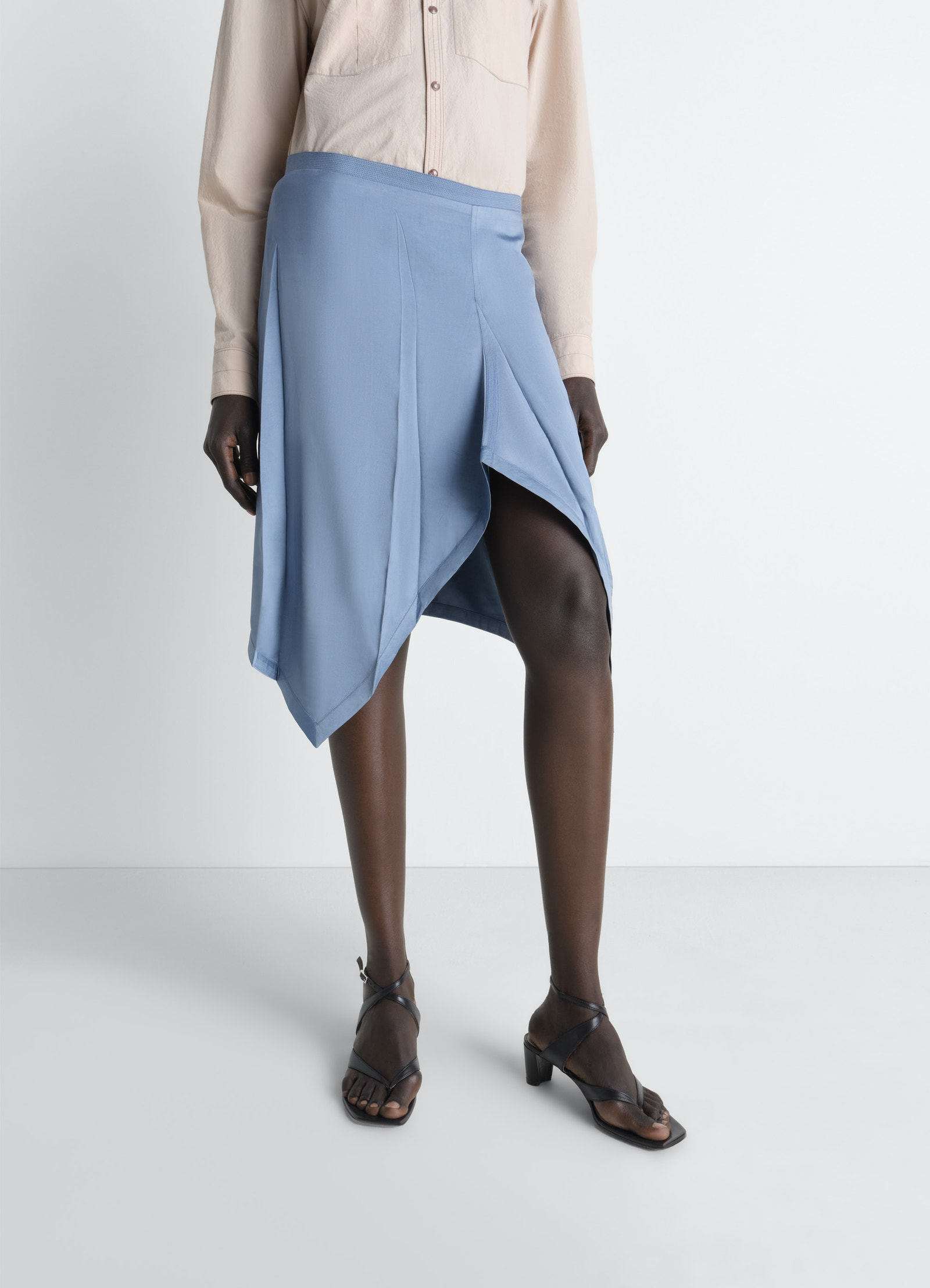 Creased foulard skirt in poly viscose twill, model shot, side view asymmetrical hem