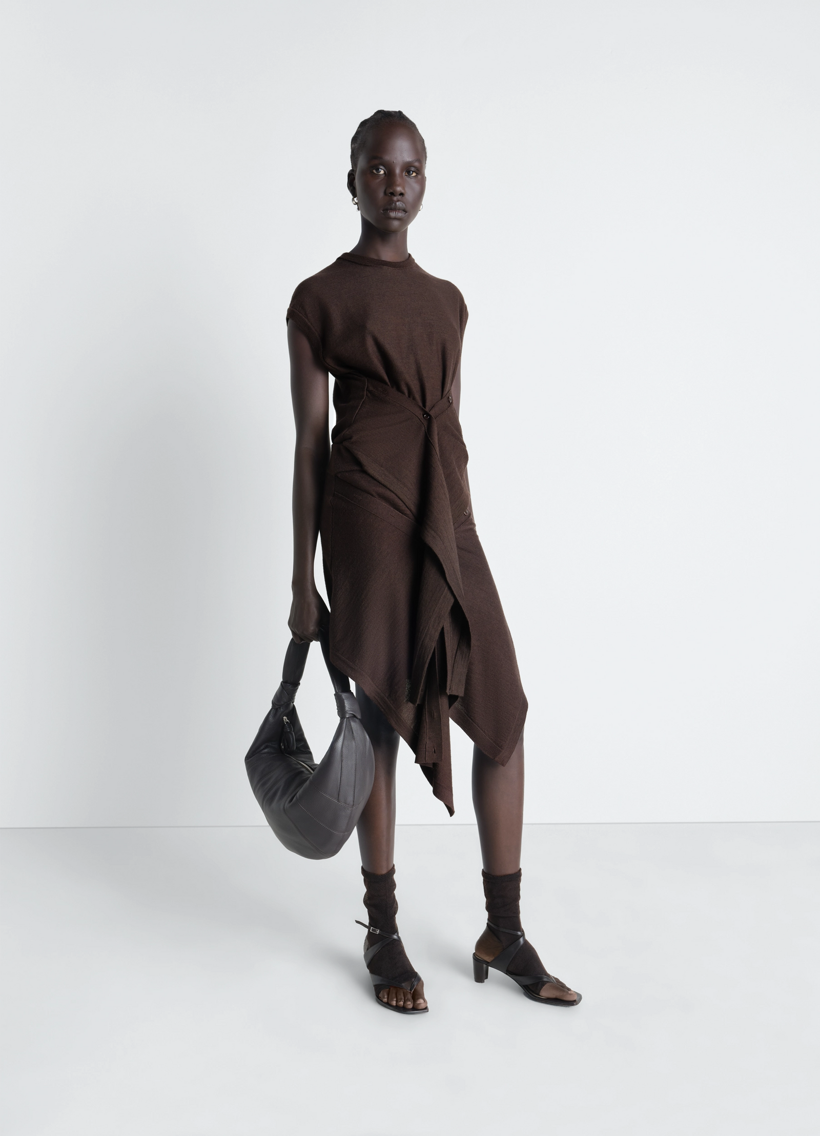 Lemaire buttoned skirt in merino wool blend, model shot, front view tied front button panels