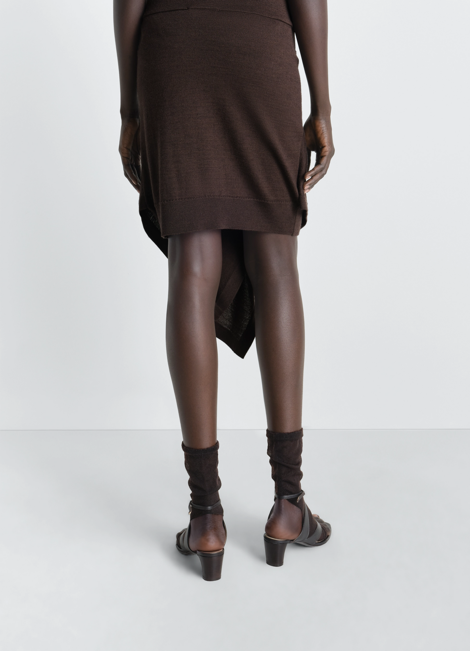 Lemaire buttoned skirt in merino wool blend, model shot, back view asymmetrical hem view 4