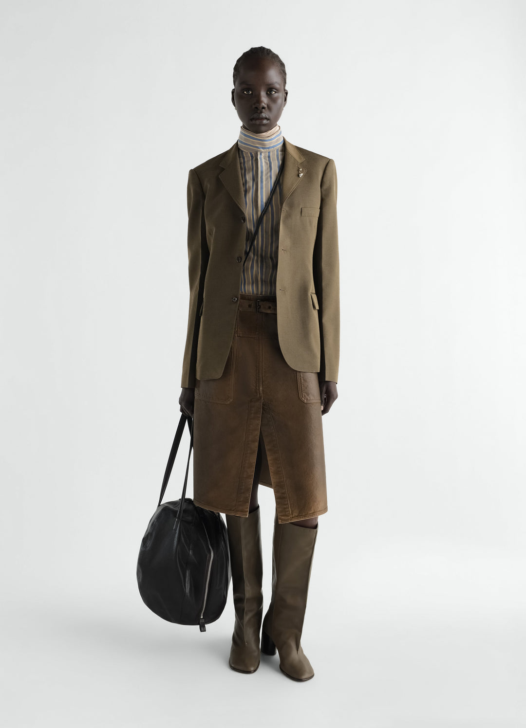Workwear skirt in brown coated denim worn by model with olive blazer and boots LEMAIRE styled look