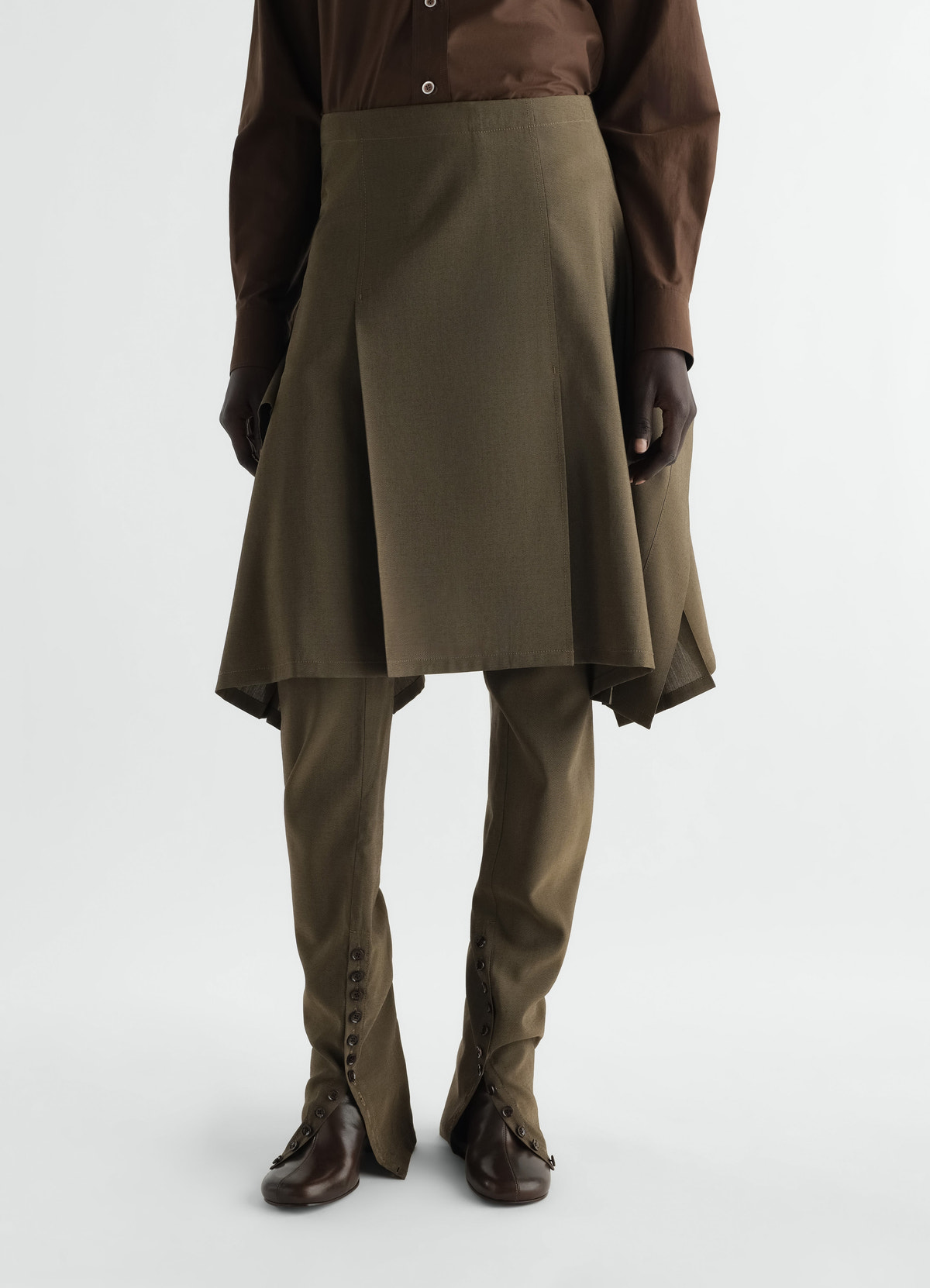 Lemaire olive wool mohair pleated skirt layered over matching trousers worn by model front view