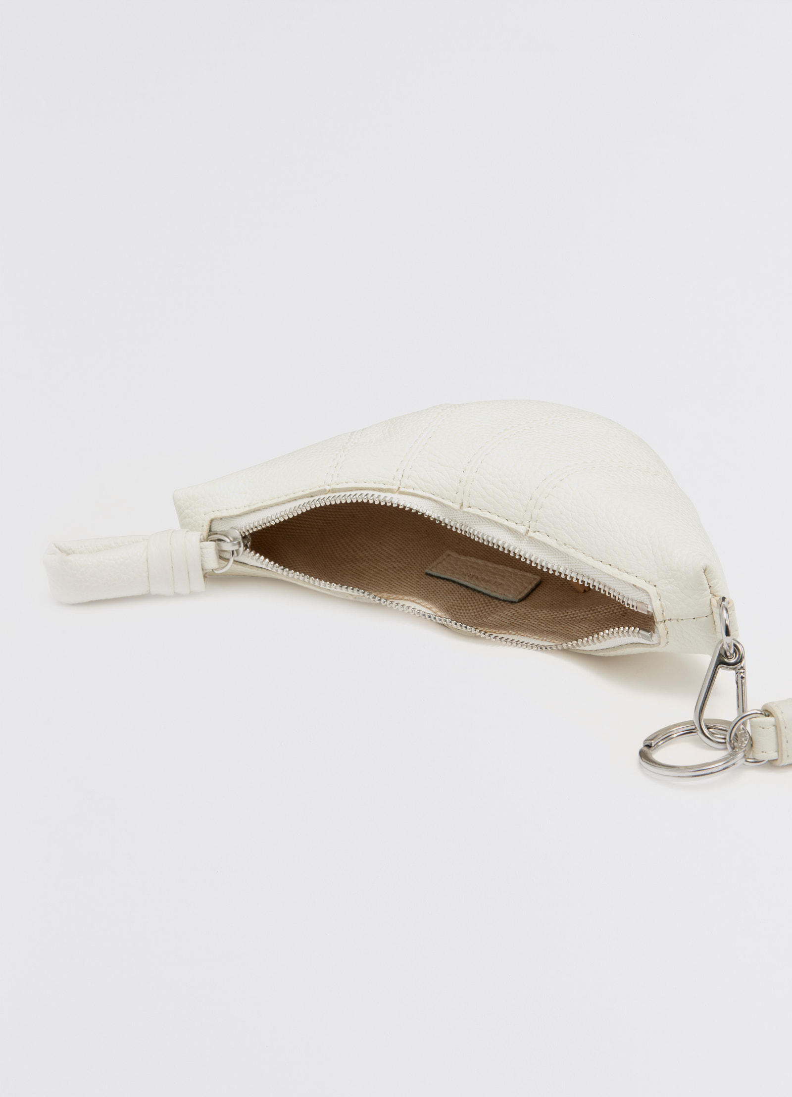 Croissant coin purse necklace in soft grained leather, product shot, top view open interior view