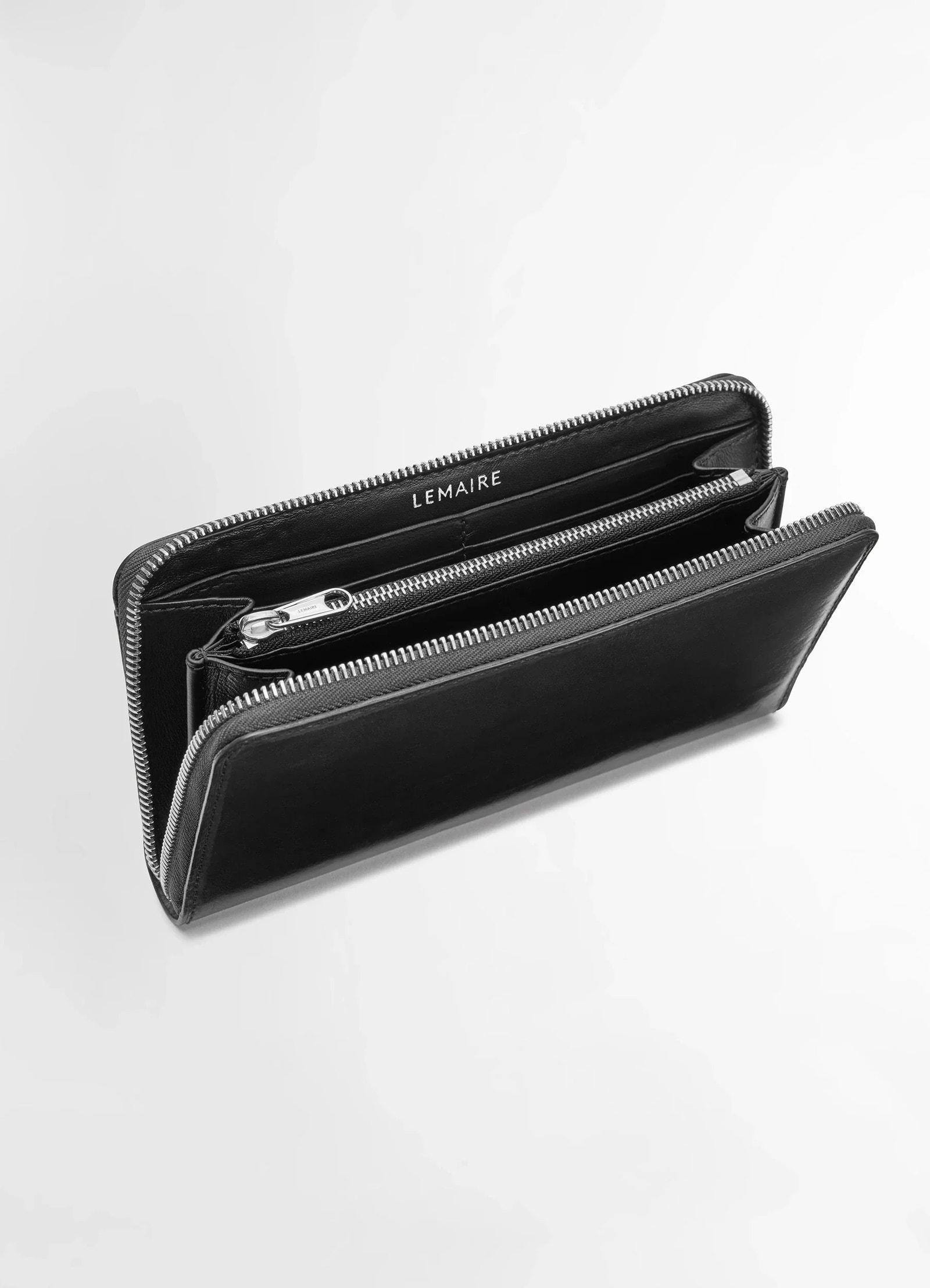 Lemaire patina zip continental in soft black leather, product shot, top angled view dual compartment zip detail