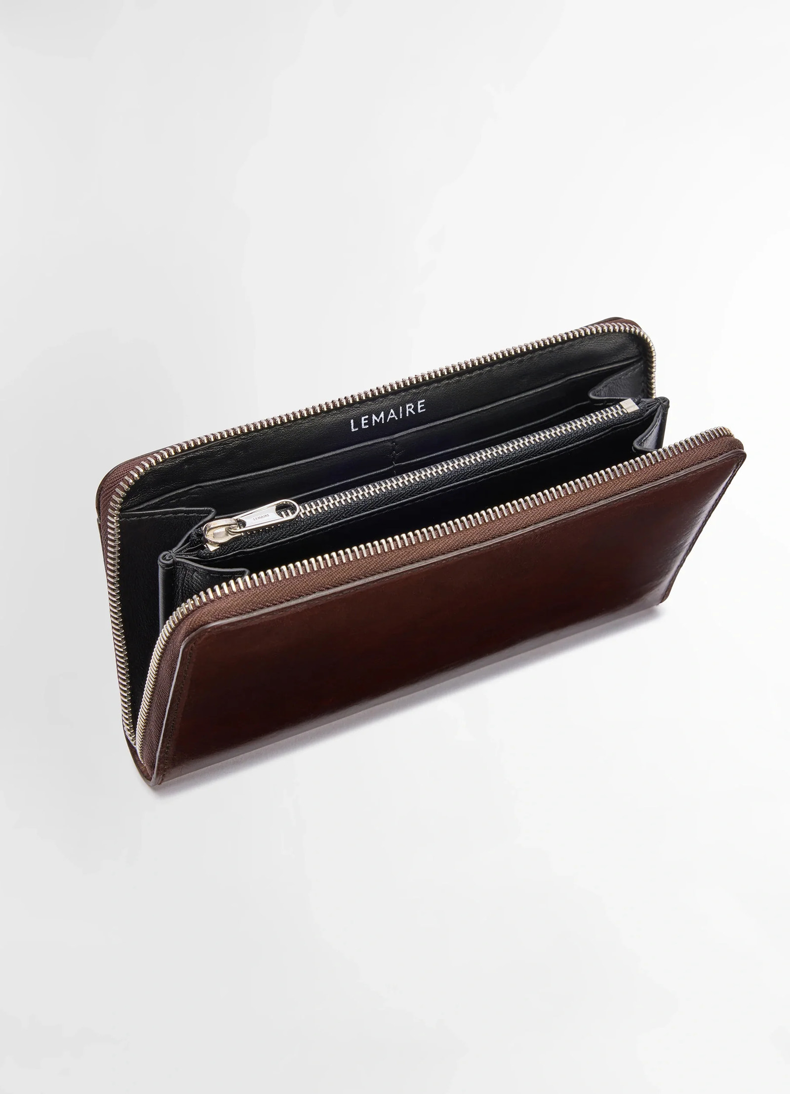 Patina zip continental in soft black leather, product shot, angled top view interior compartments visible