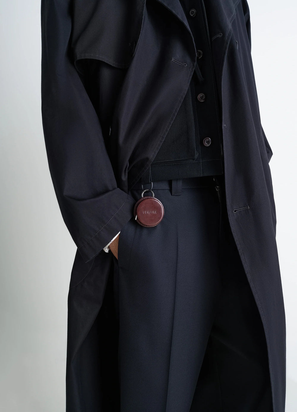 Lemaire Molded Tape Necklace in Patinated Silver LWG-certified Leat, model shot, side detail shot visible clasp on dark fabri