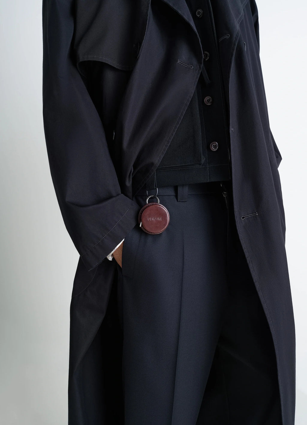 Lemaire Molded Tape Necklace in Patinated Silver LWG-certified Leat, model shot, side detail shot visible clasp on dark fabri