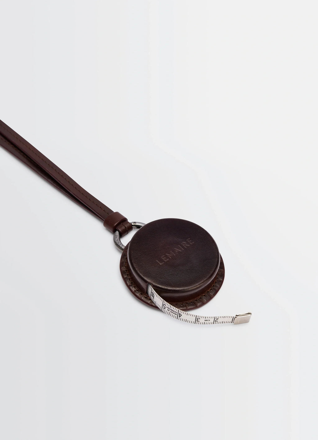 Lemaire Molded Tape Necklace in Patinated Silver LWG-certified Leat, product shot, top angled view compact reel detail