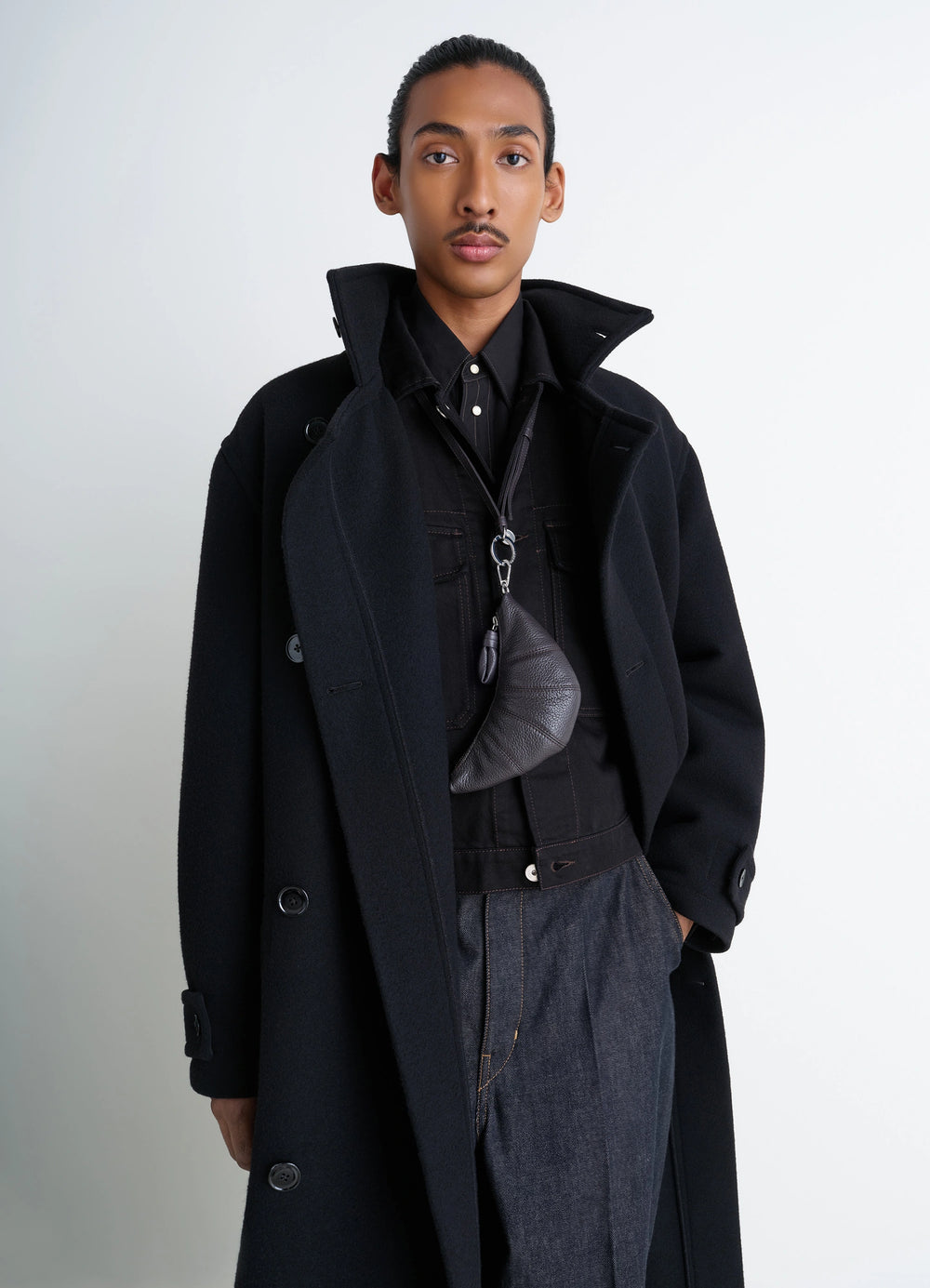 Cross-Body Croissant Coin Purse in Grained Leather, model shot, Front view Folded half-moon design