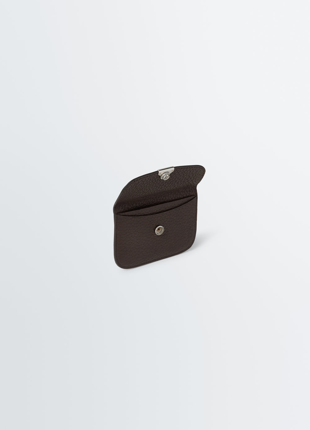 Soft tab card holder in dark brown leather with silver snap closure by LEMAIRE on plain white background