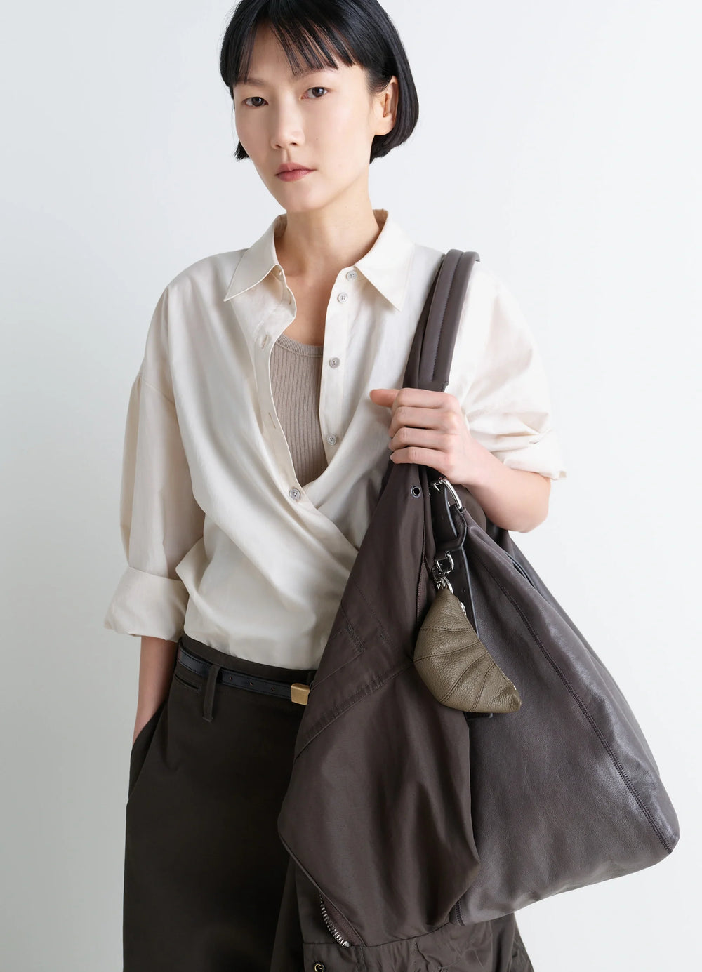 Mini Croissant Keyring in Grained Leather, model shot, porte view textured leather finish