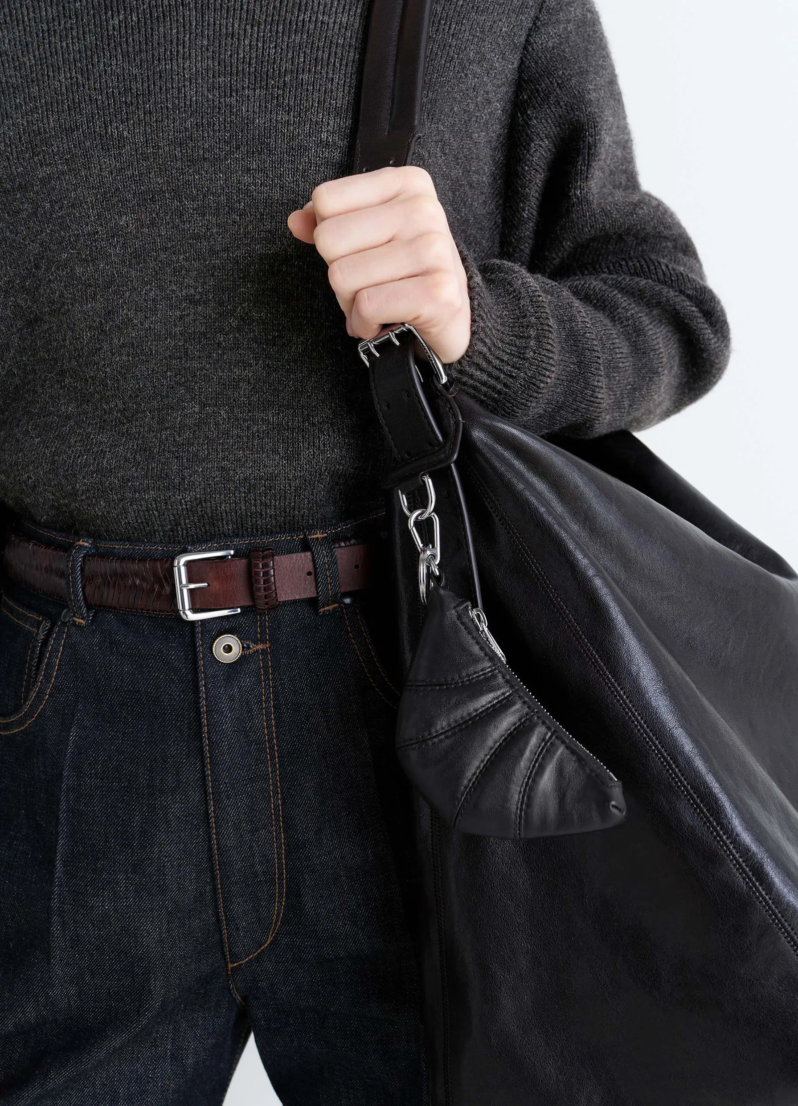 Mini croissant keyring in black nappa leather, detail shot folded half-moon design