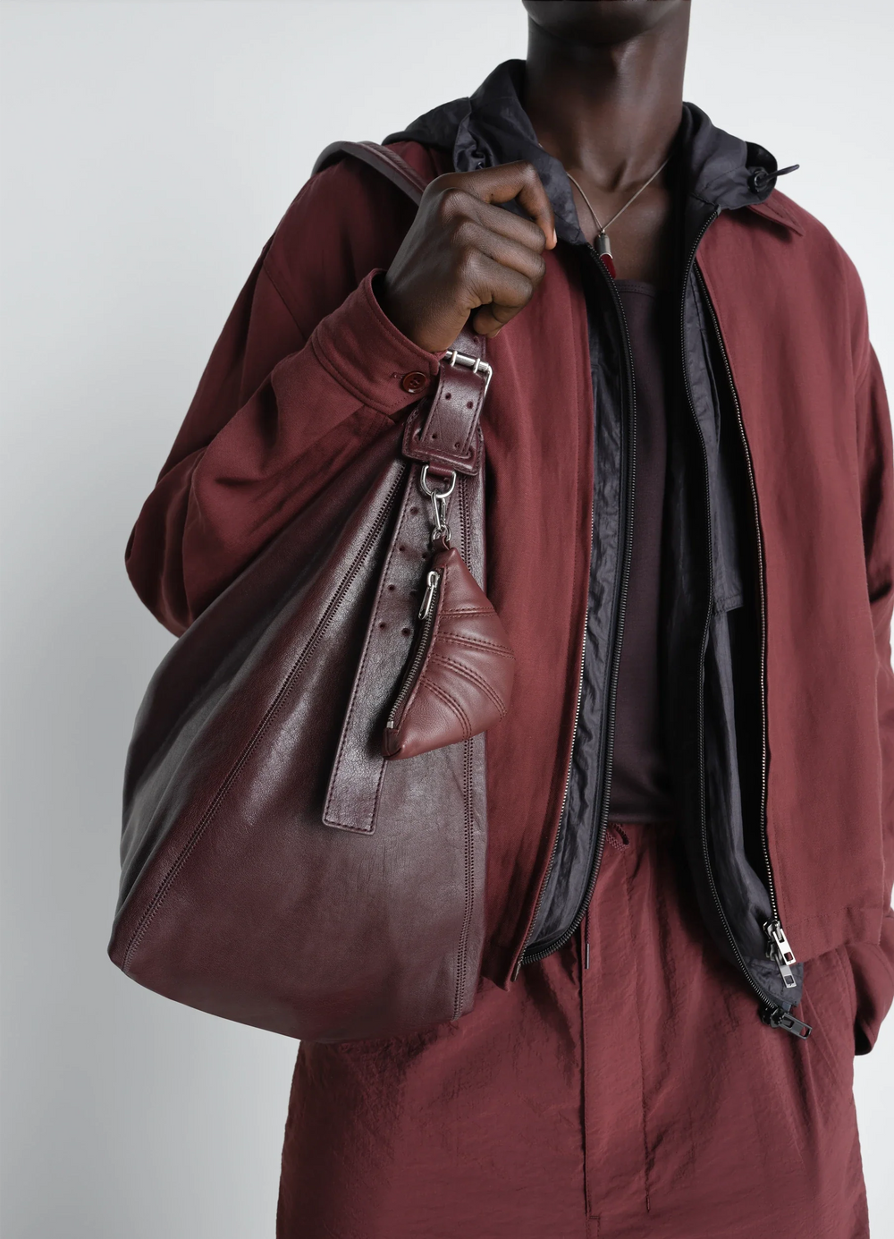 Mini Croissant Keyring in Nappa Leather Shiny, model shot, detail shot attached to large bag