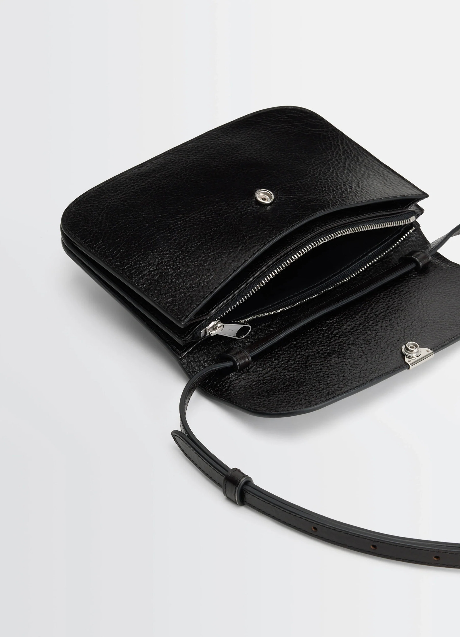 Soft tab wallet on strap in black leather, product shot, open top view zip pocket detail