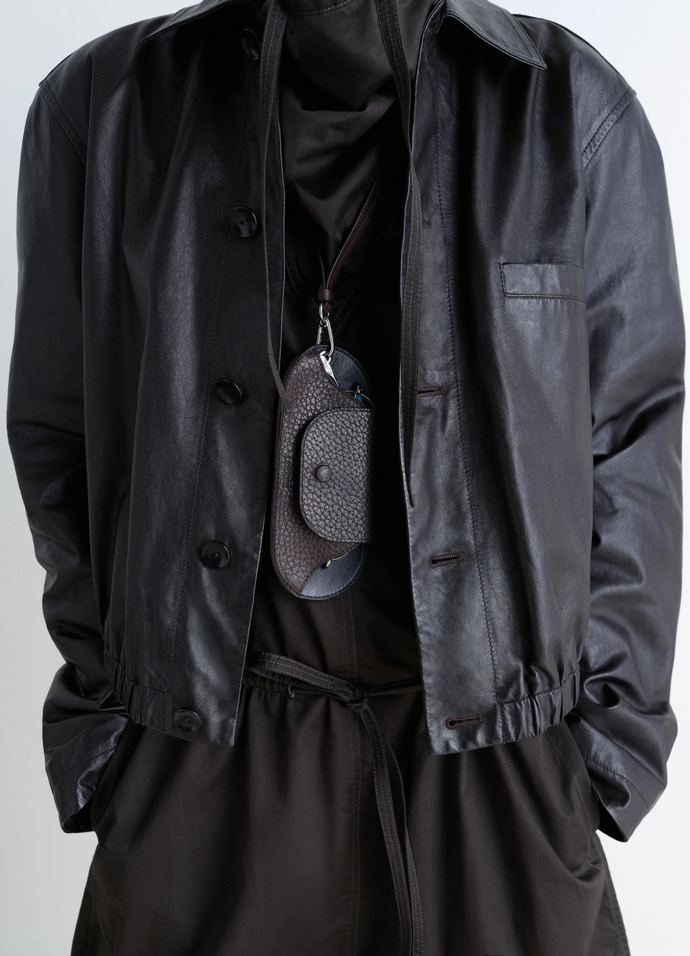 Bell Glasses Holder in Grained Leather, model shot, hanging front angle textured closure flap