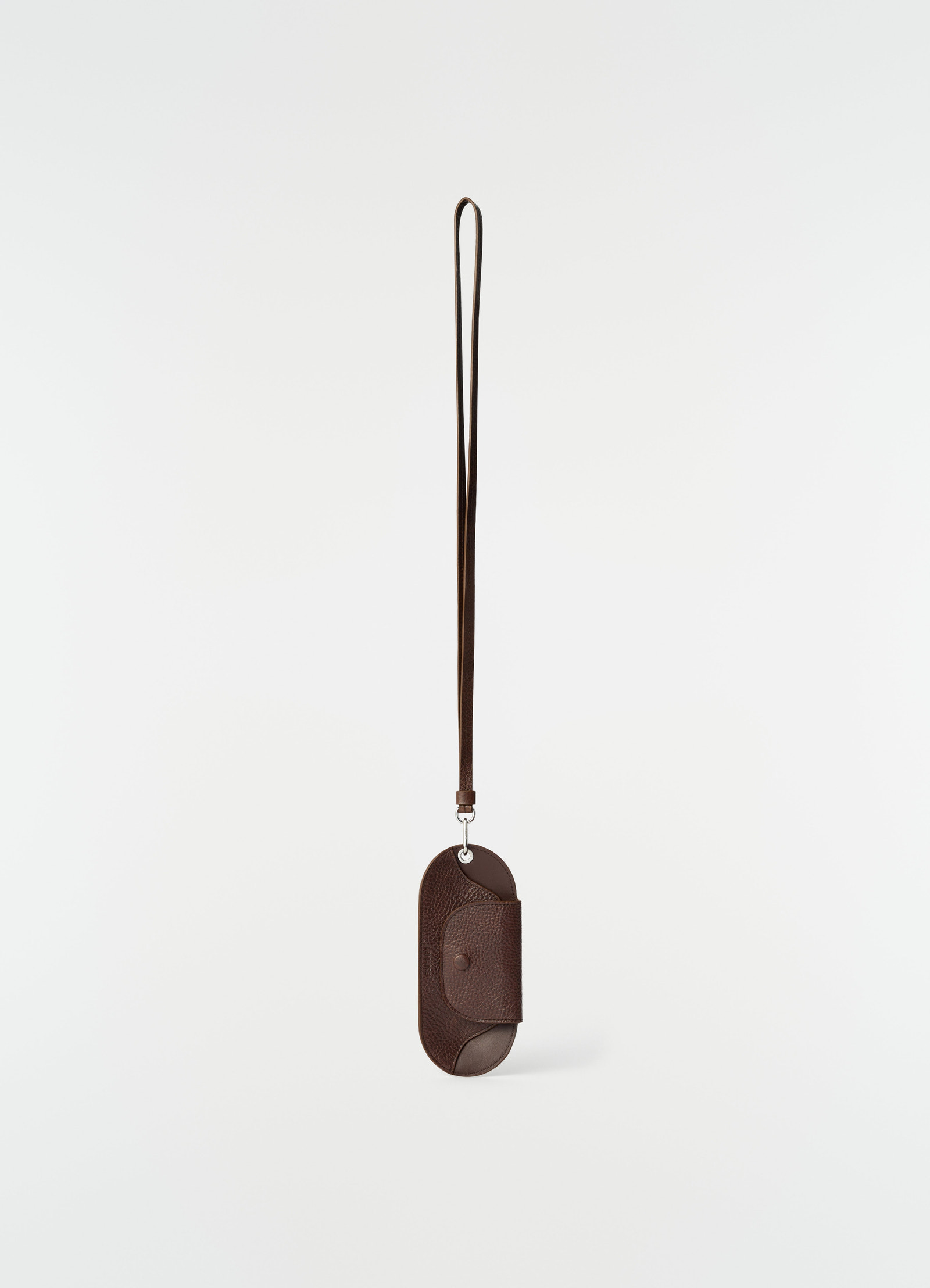Glasses case in glossy dark brown vegetable-tanned leather with strap by lemaire on plain white background