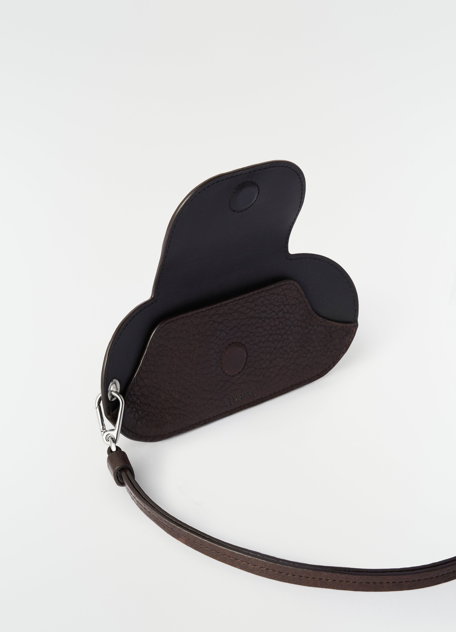 Glasses case in dark brown glossy vegetable-tanned leather by lemaire open front view with wrist strap on white background
