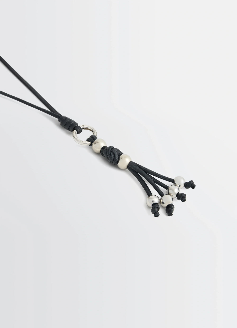 Infinite Love Knot Badge Holder in Nappa Lamb Leather, product shot, angled close-up tassel and bead accents