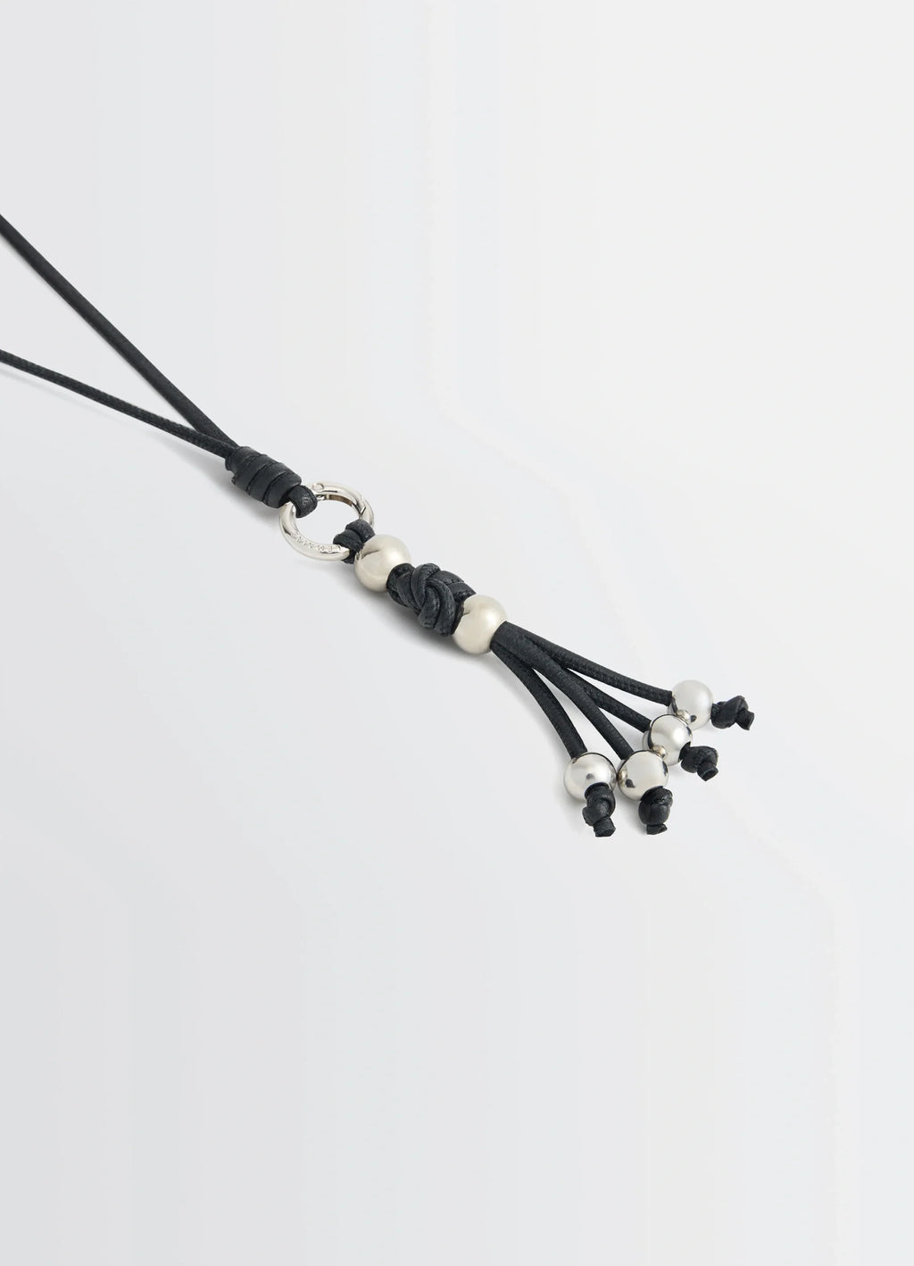Infinite Love Knot Badge Holder in Nappa Lamb Leather, product shot, angled close-up tassel and bead accents