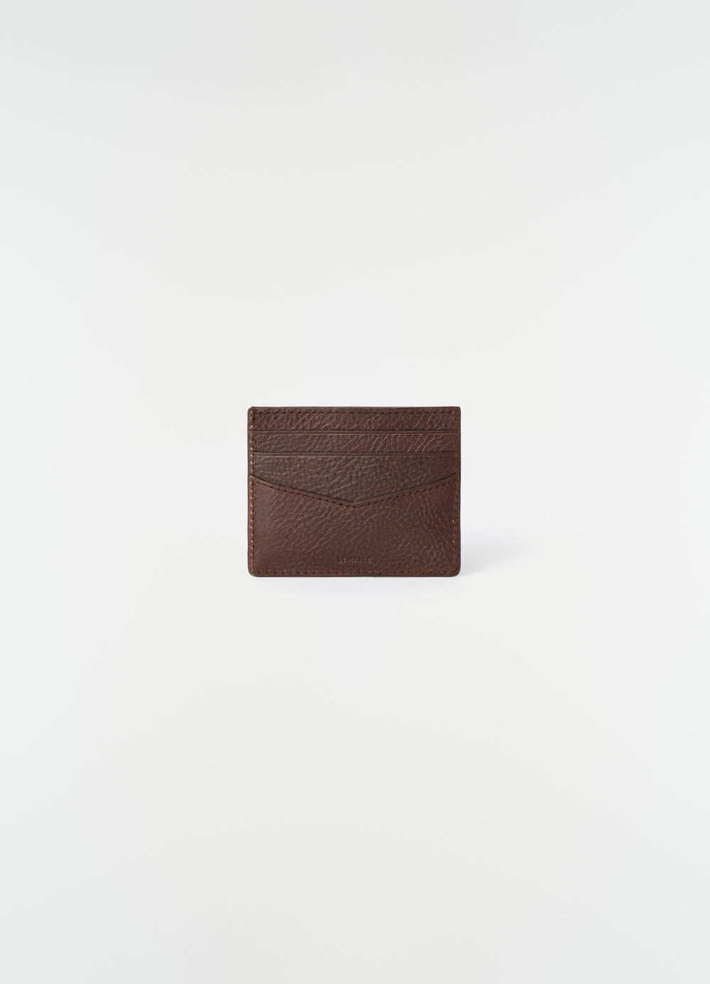Leather brown card holder with embossed logo by LEMAIRE front view on white background