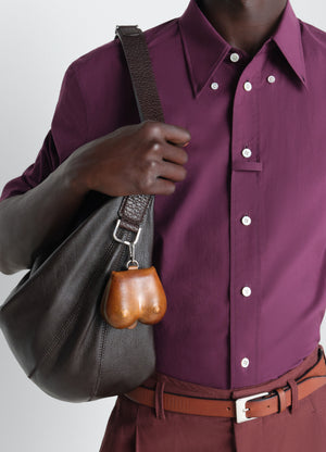 Carlos breast key ring in vegetable-tanned leather, model shot, worn by model attached to strap