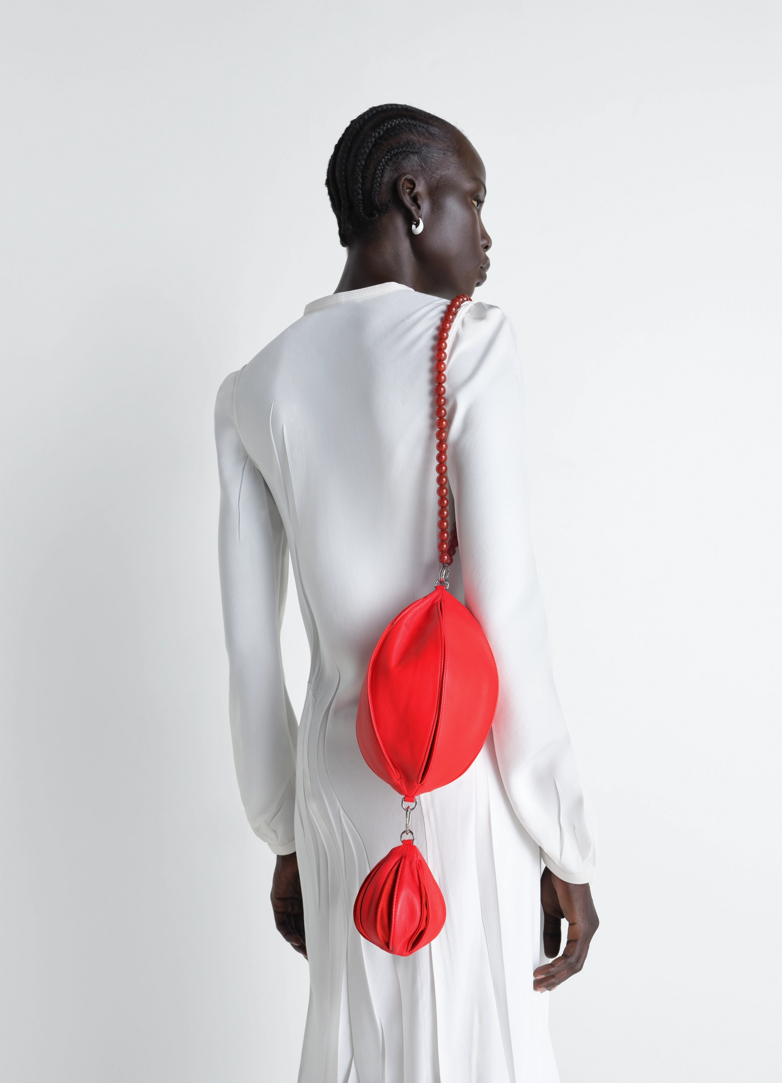 Balloon bag charm in red lamb nappa leather, model shot, back view worn with chain strap