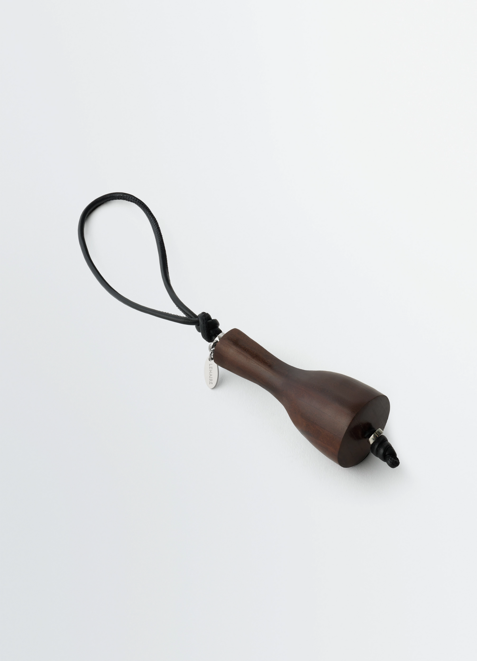 Bottle heel charm in leather, product shot, top angle view curved shape