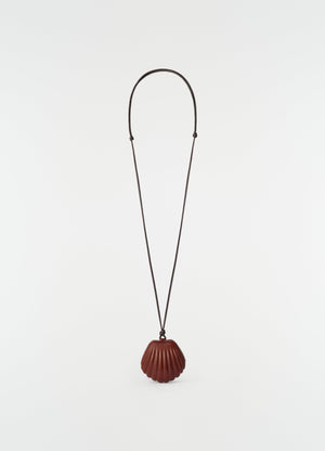 Shell mirror pendant necklace lemaire in brown patinated calfskin with long cord on white background