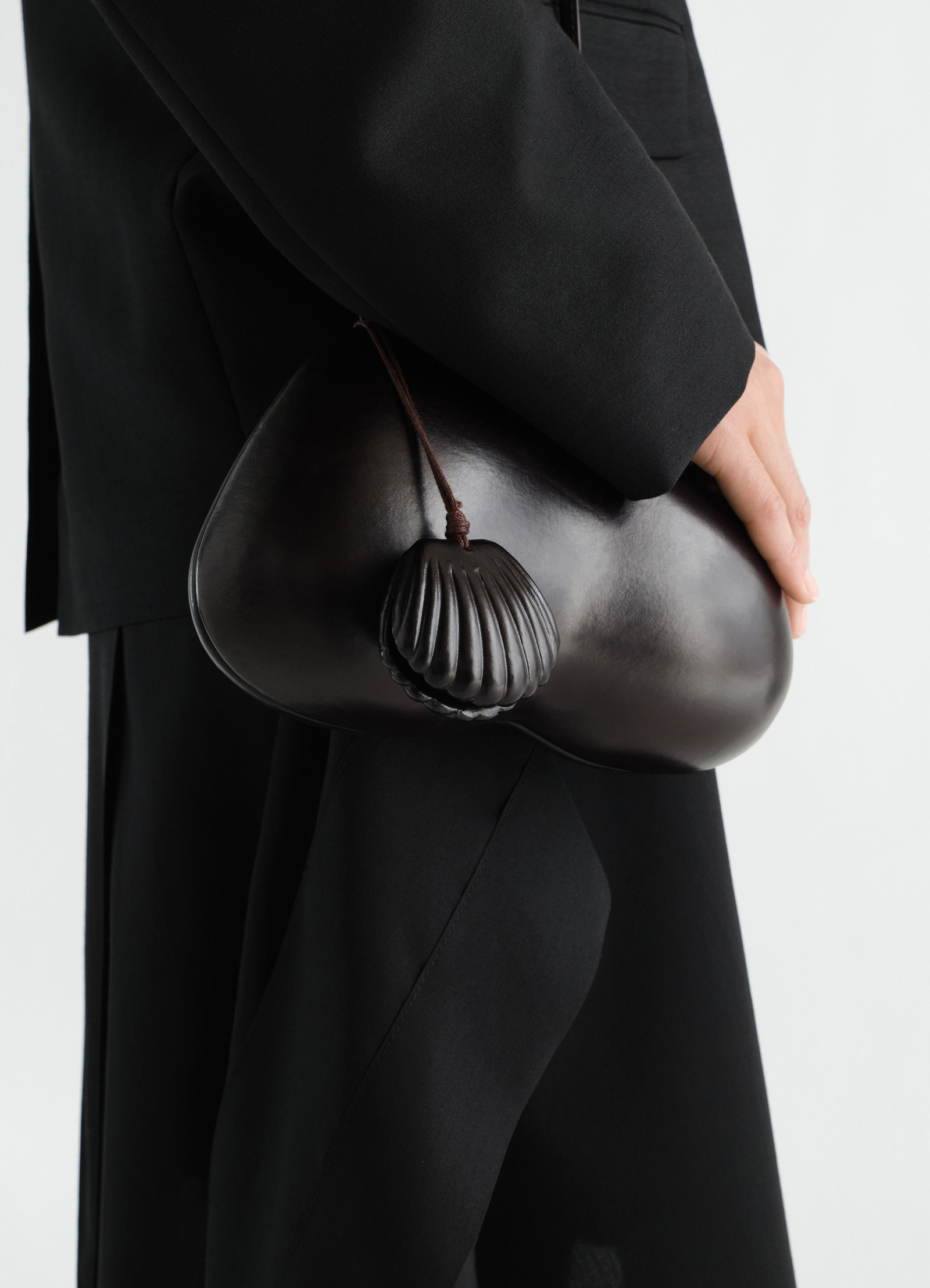 Shell mirror calfskin bag in dark brown leather by lemaire worn by model side view close-up detail