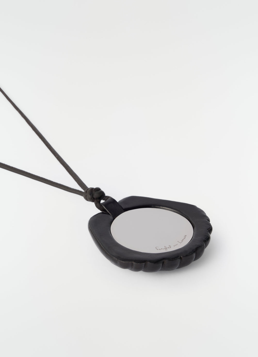 Shell mirror pendant in black patinated calfskin leather by LEMAIRE on plain white background detail