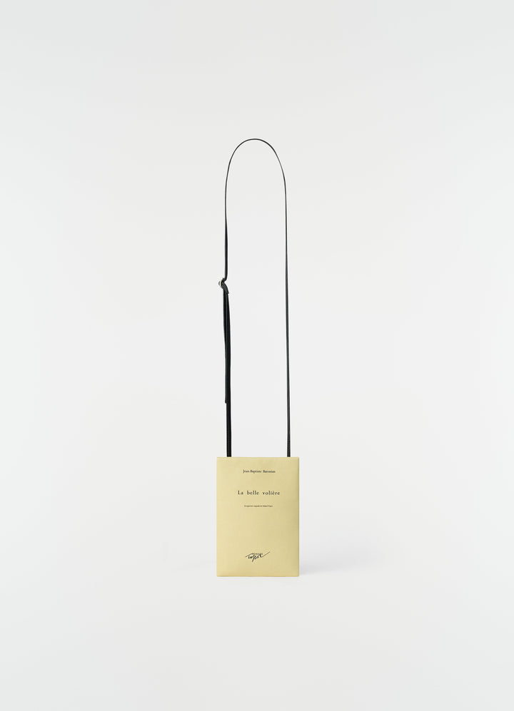 Small yellow printed nappa leather book pouch with black strap by LEMAIRE on plain white background