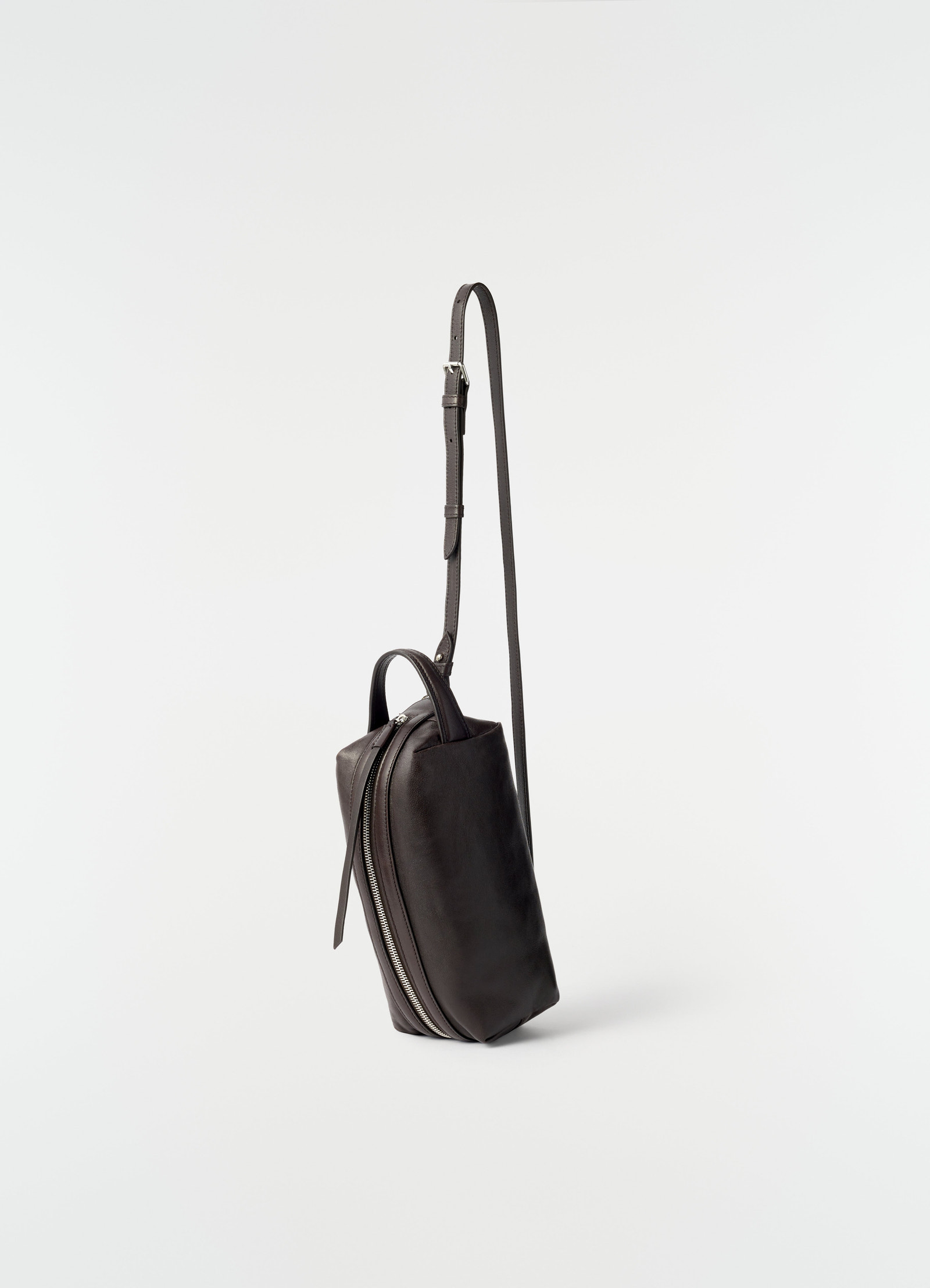 Small black nappa lambskin care bag with silver zipper and adjustable strap by lemaire on plain white background
