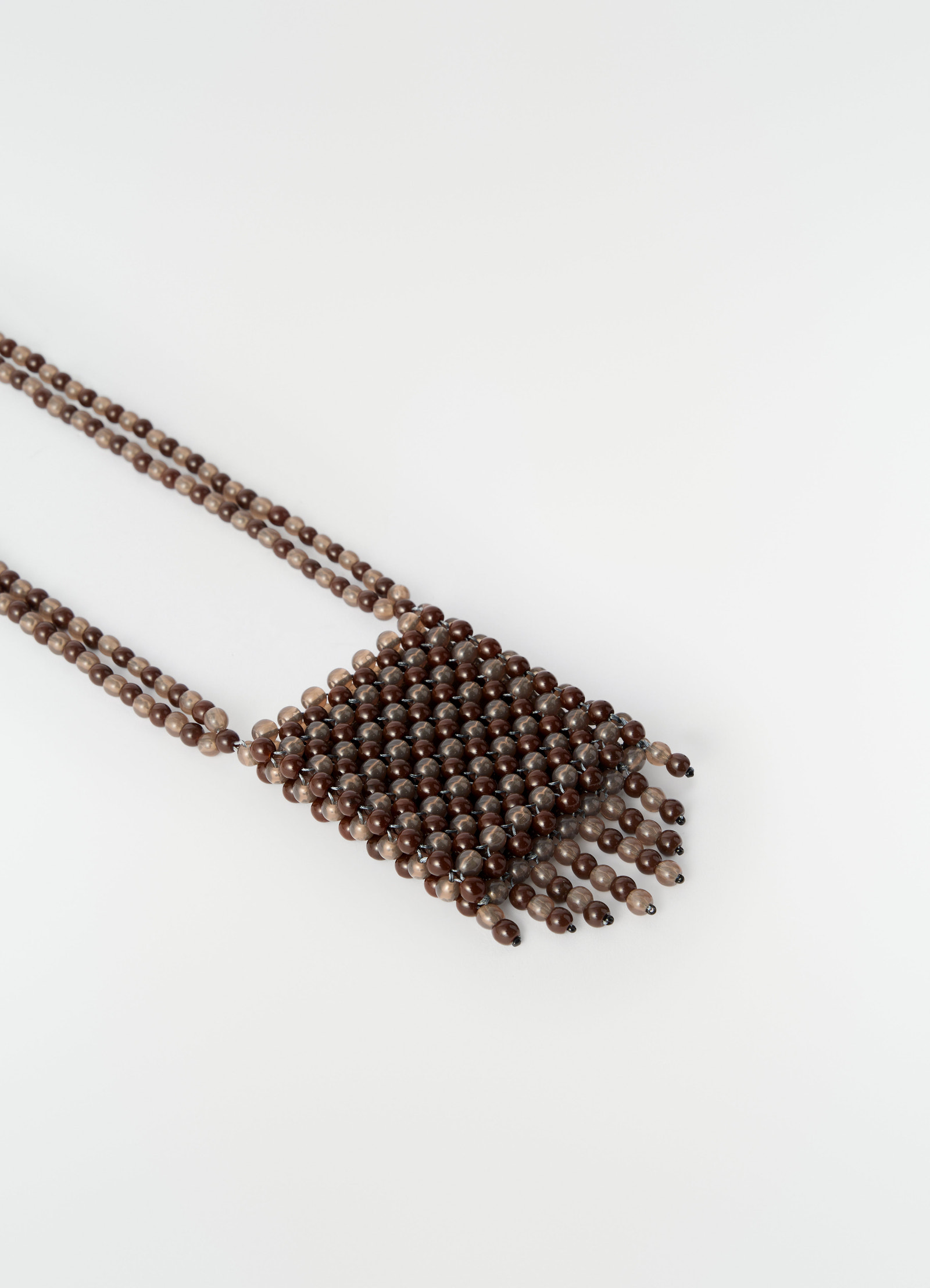 Grigri bag necklace in brown resin beads with fringed edge by lemaire on plain white background