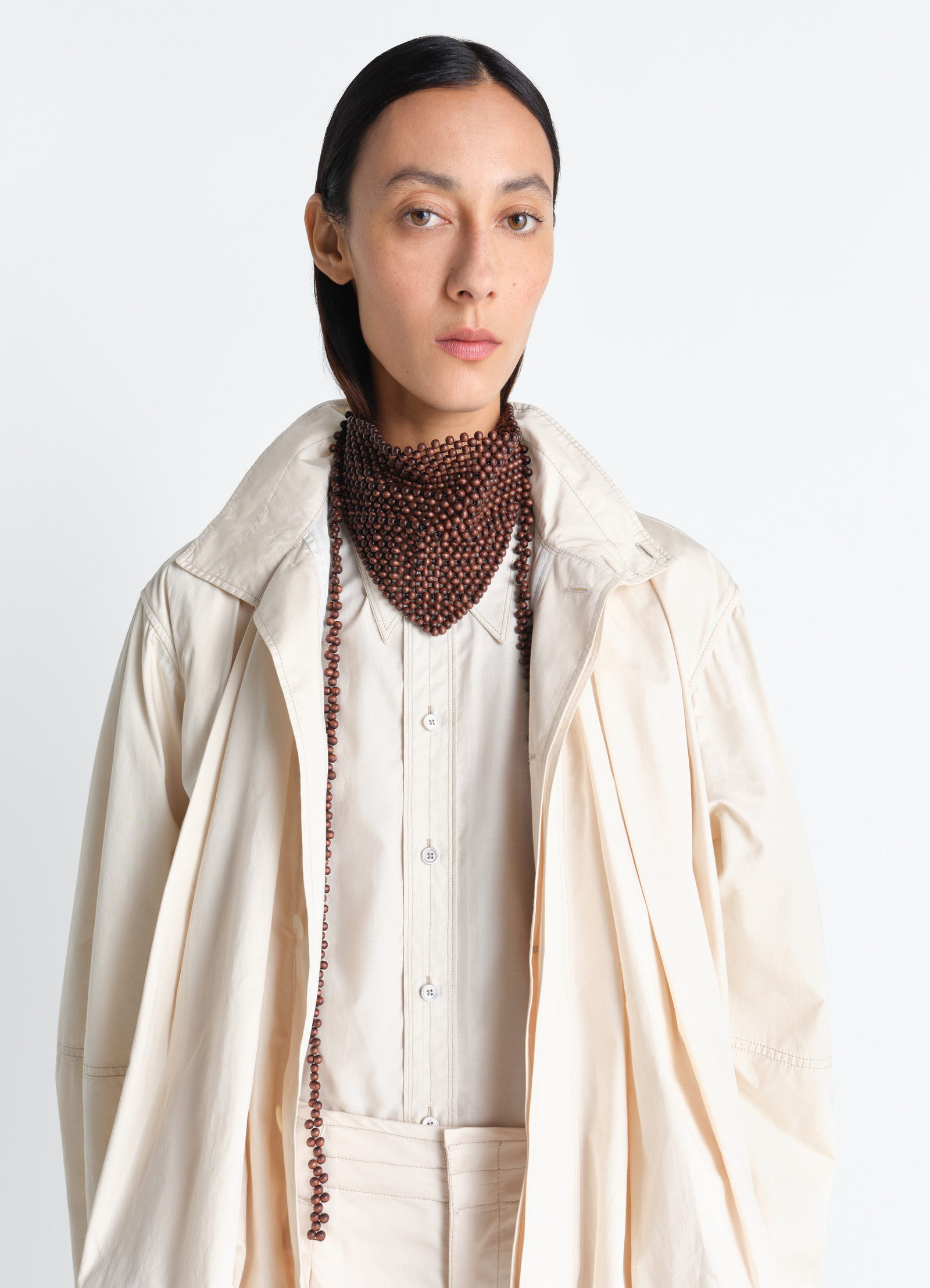 Wooden beads bandana necklace in wooden beads in neutral tones, model shot, front close-up view layered bead strands