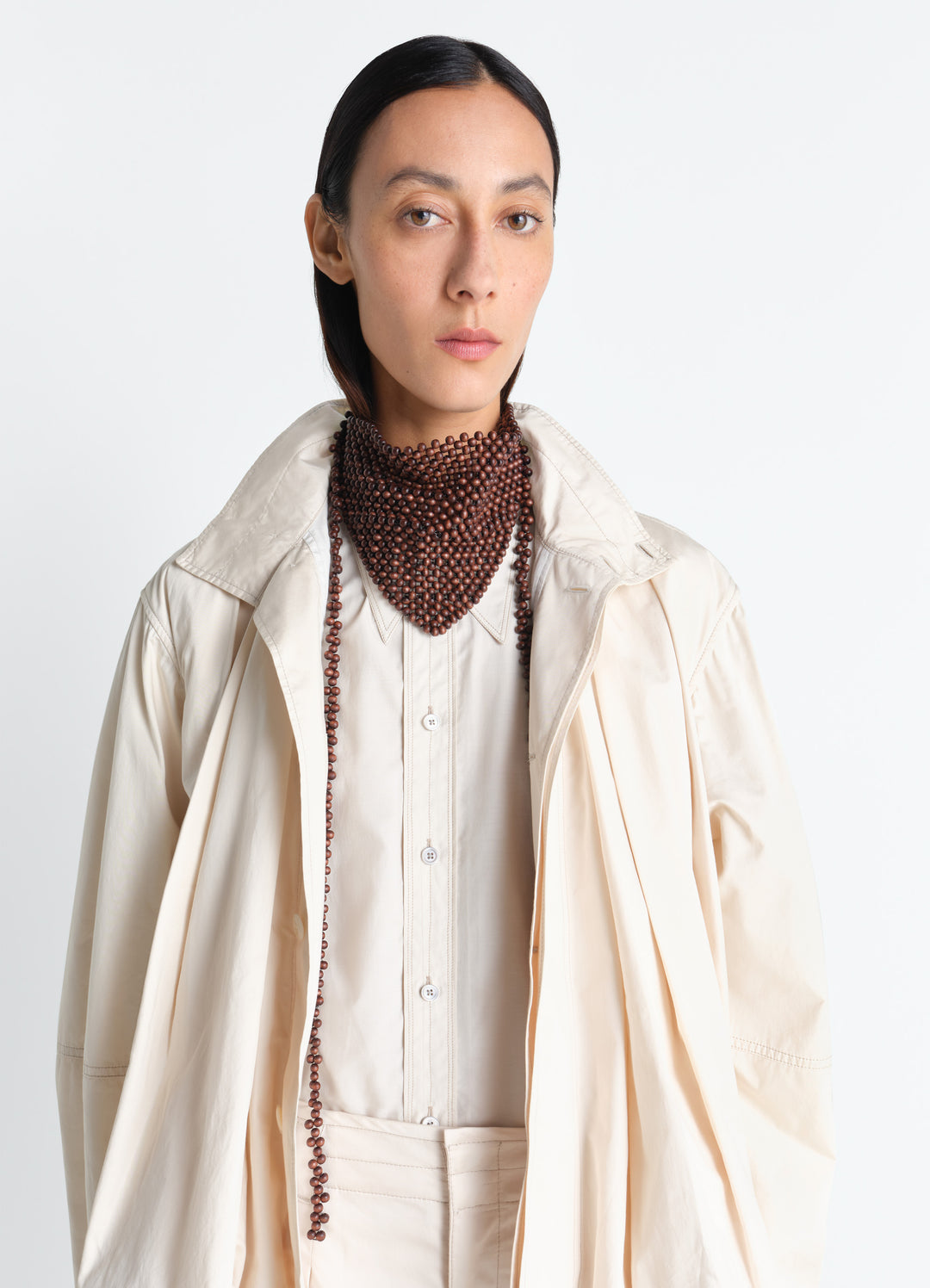 Wooden Beads Bandana Necklace in Wooden beads in neutral tones, model shot, front close-up view layered bead strands