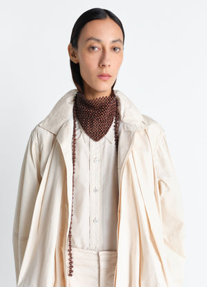 Wooden beads bandana necklace in wooden beads in neutral tones, model shot, front close-up view layered bead strands