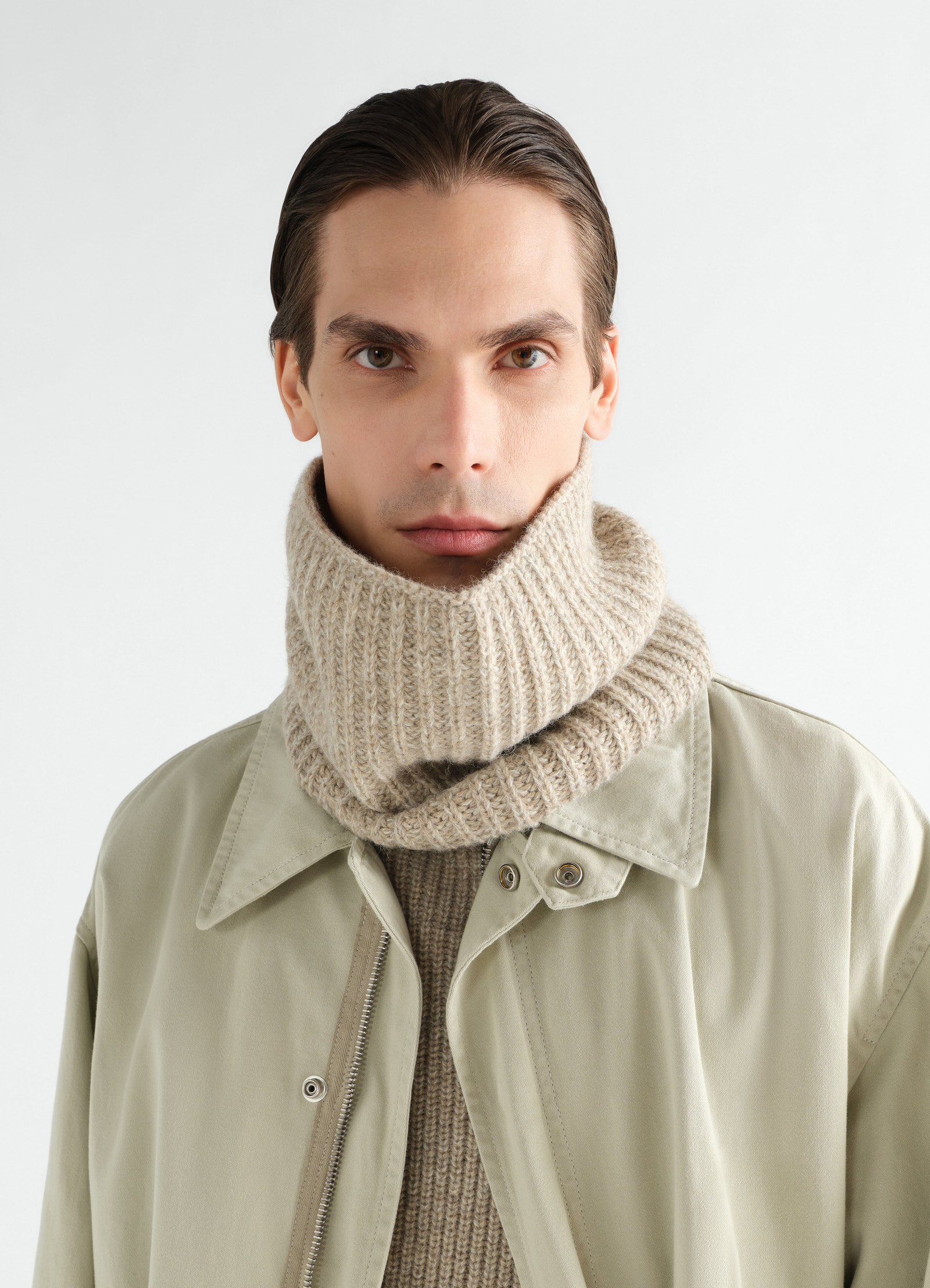 Neck warmer in beige alpaca and yak wool blend worn by model with light khaki jacket lemaire front view