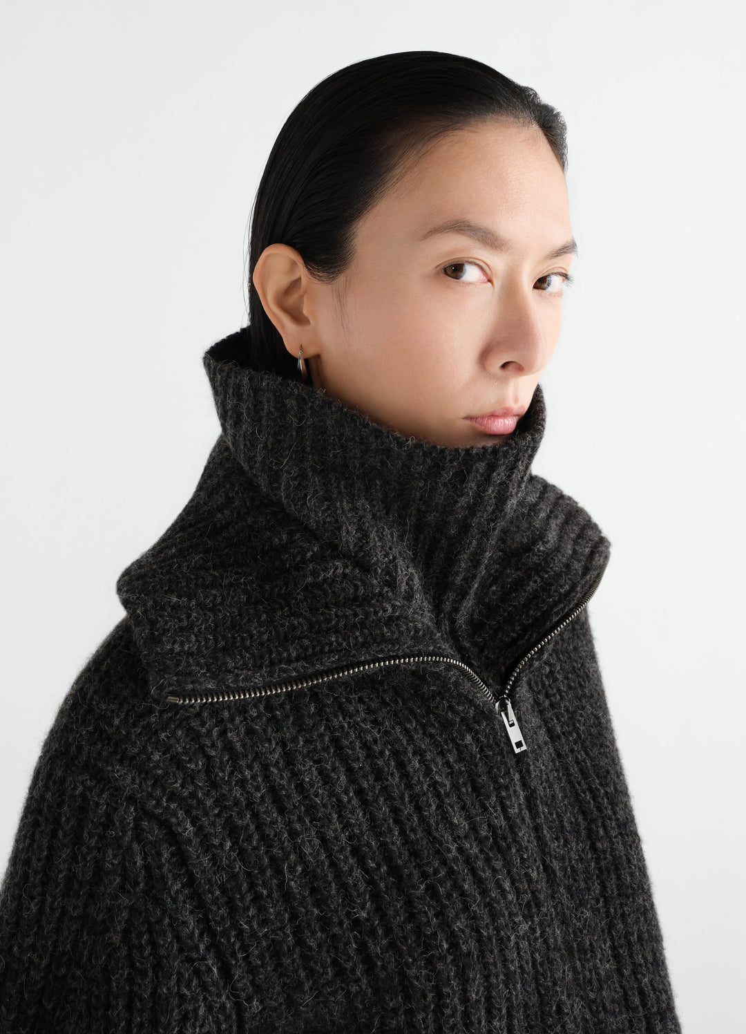 Neck warmer in dark grey alpaca and yak wool blend by LEMAIRE worn by model close-up front side view