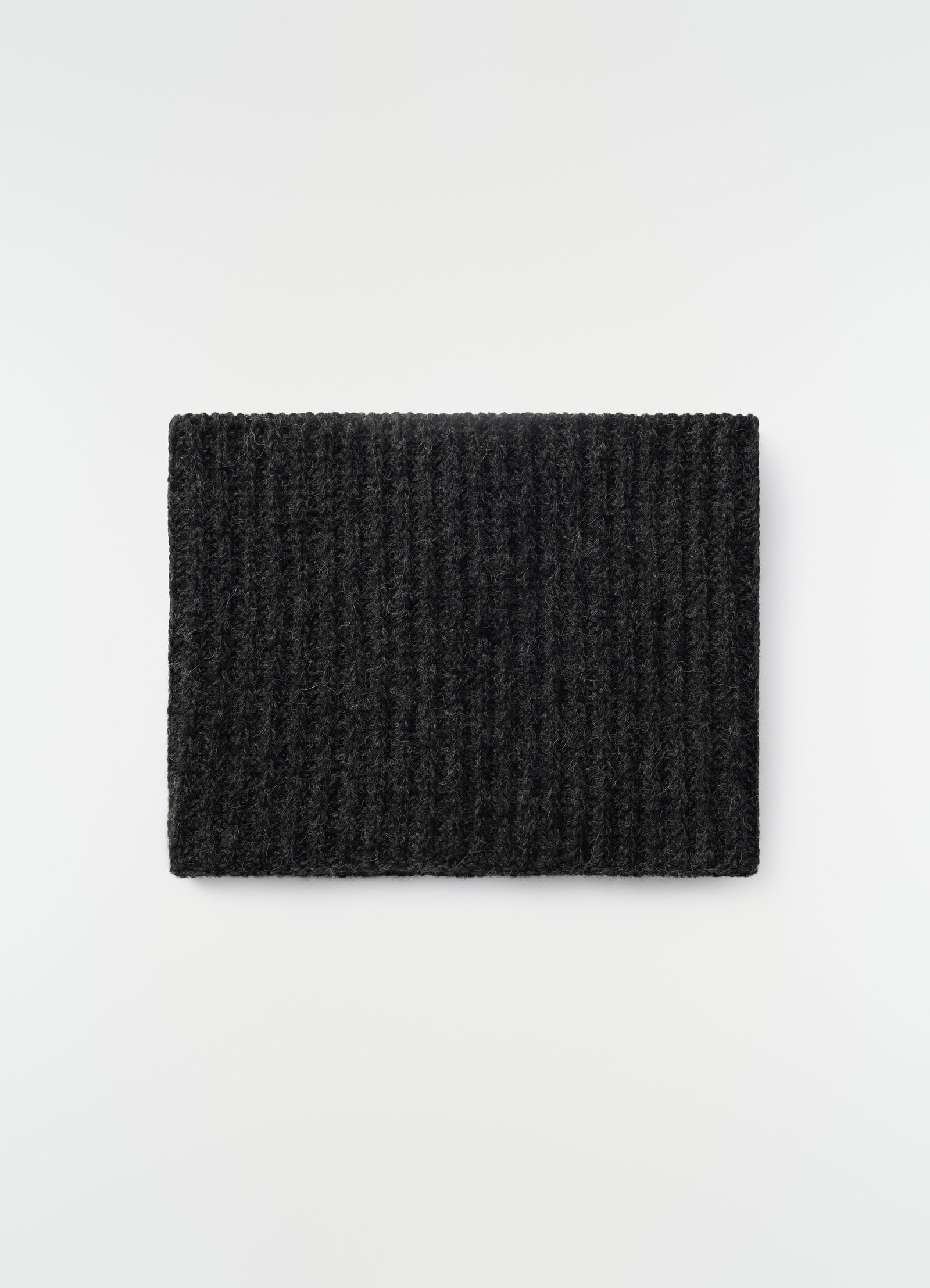 Neck warmer in black alpaca and yak wool blend by lemaire flat lay on white background