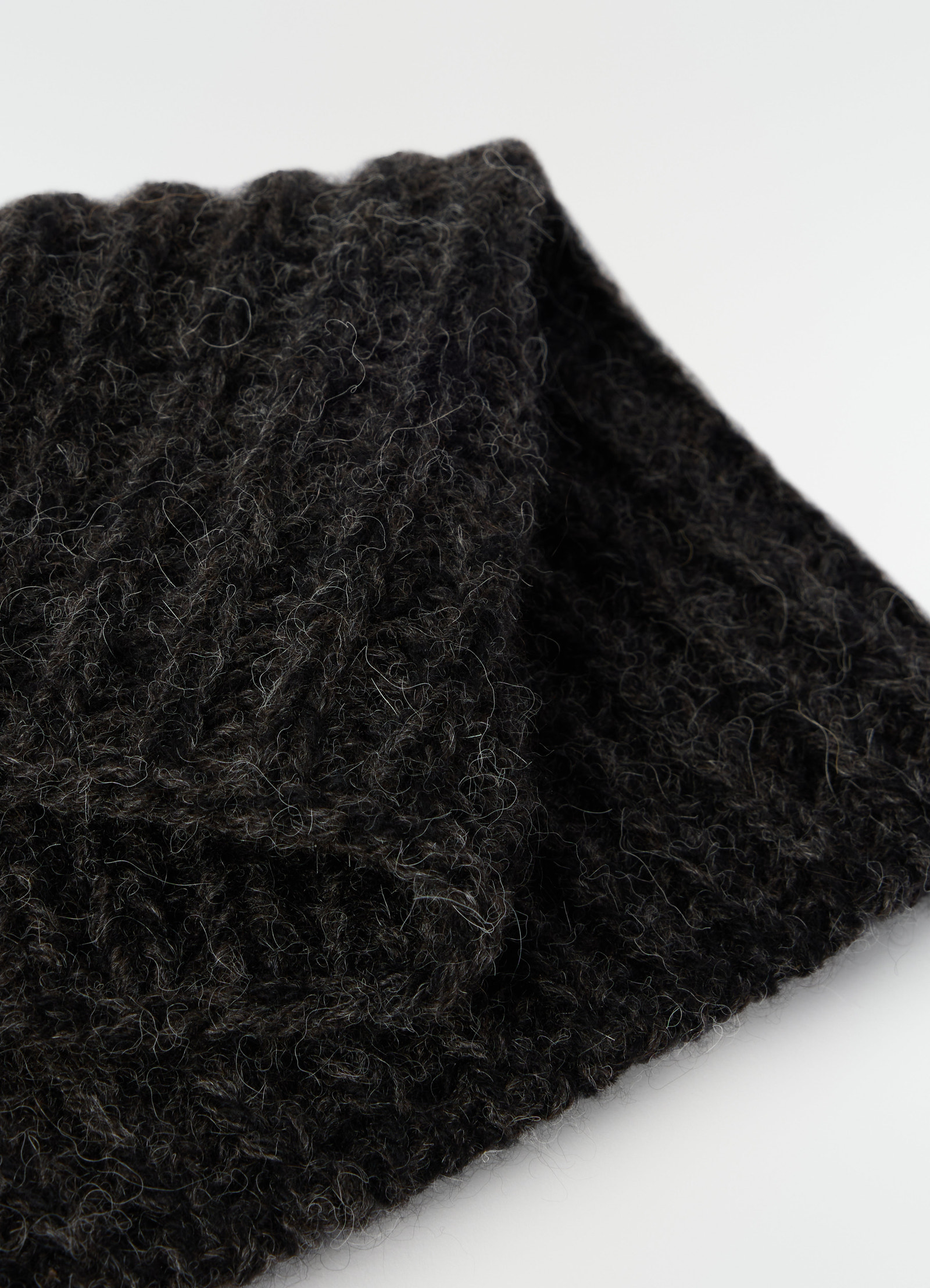 Neck warmer lemaire black alpaca and yak wool blend close-up detail on plain white background