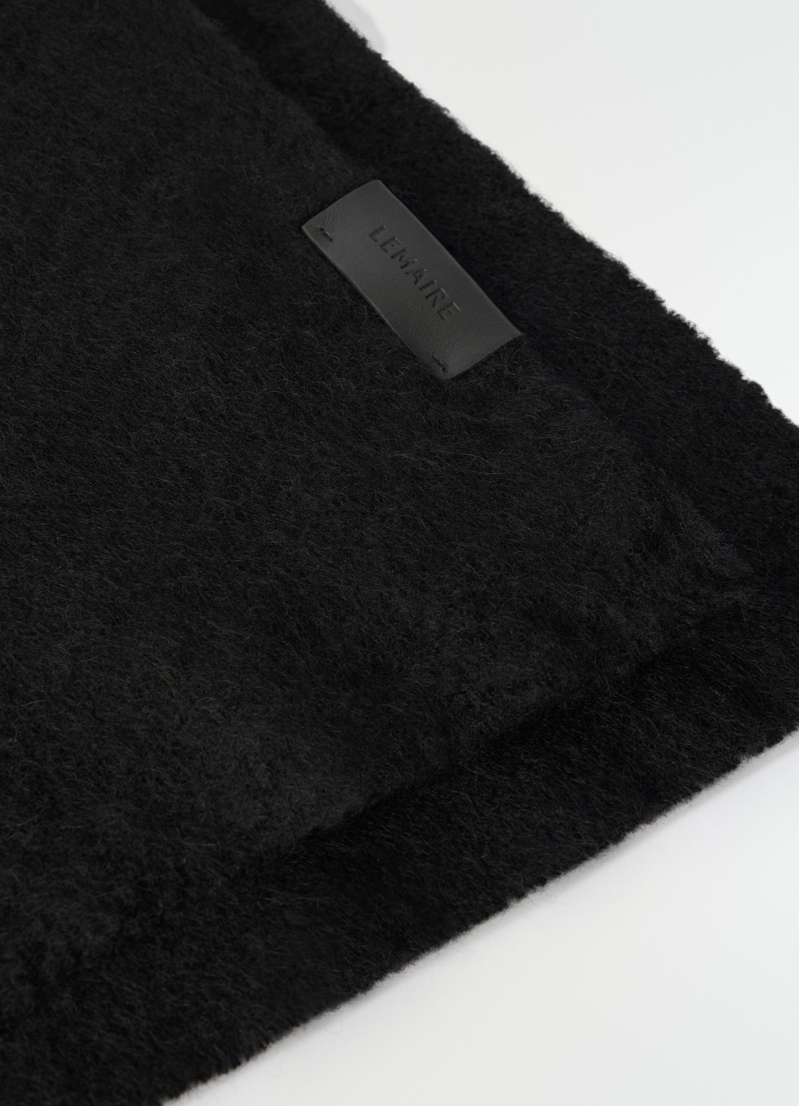 Fluffy black alpaca wool blend scarf by lemaire close-up detail showing texture and label