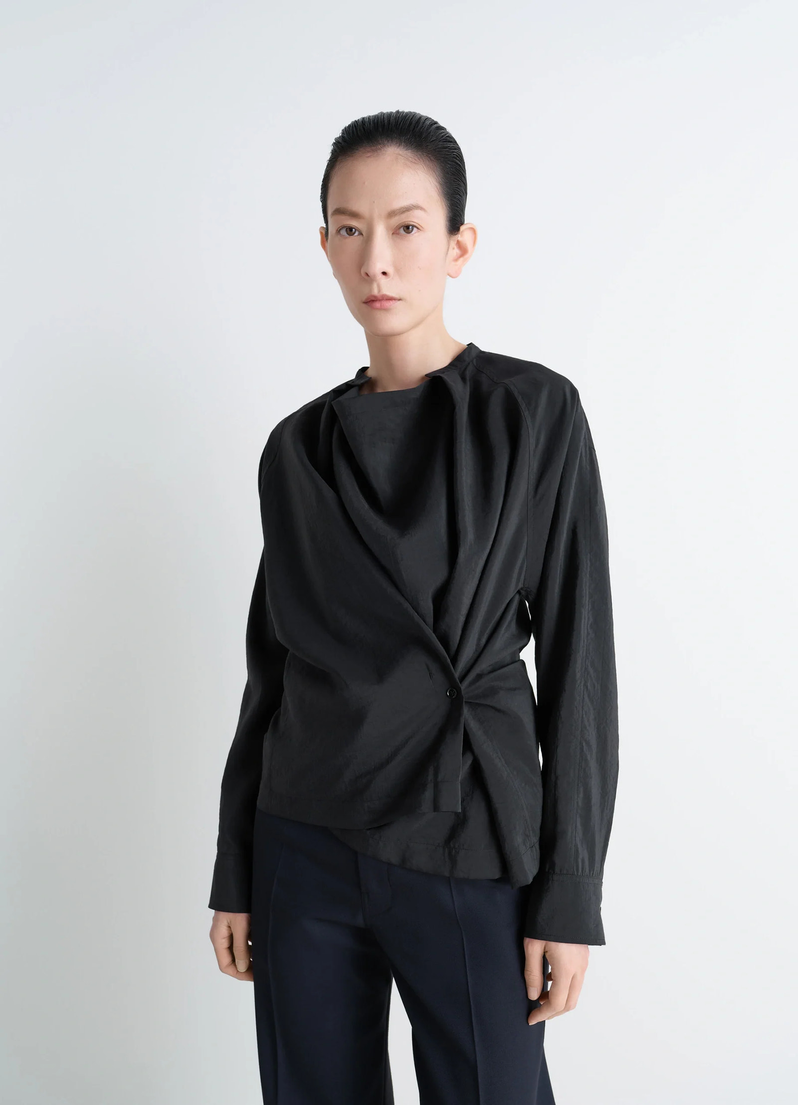 Lemaire twisted top in black dry silk blend, model shot, front view long-sleeved fitted cut