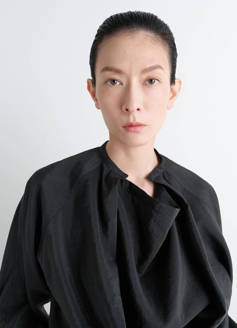 Lemaire Twisted Top in Black Dry Silk Blend, model shot, close-up view asymmetrical neckline