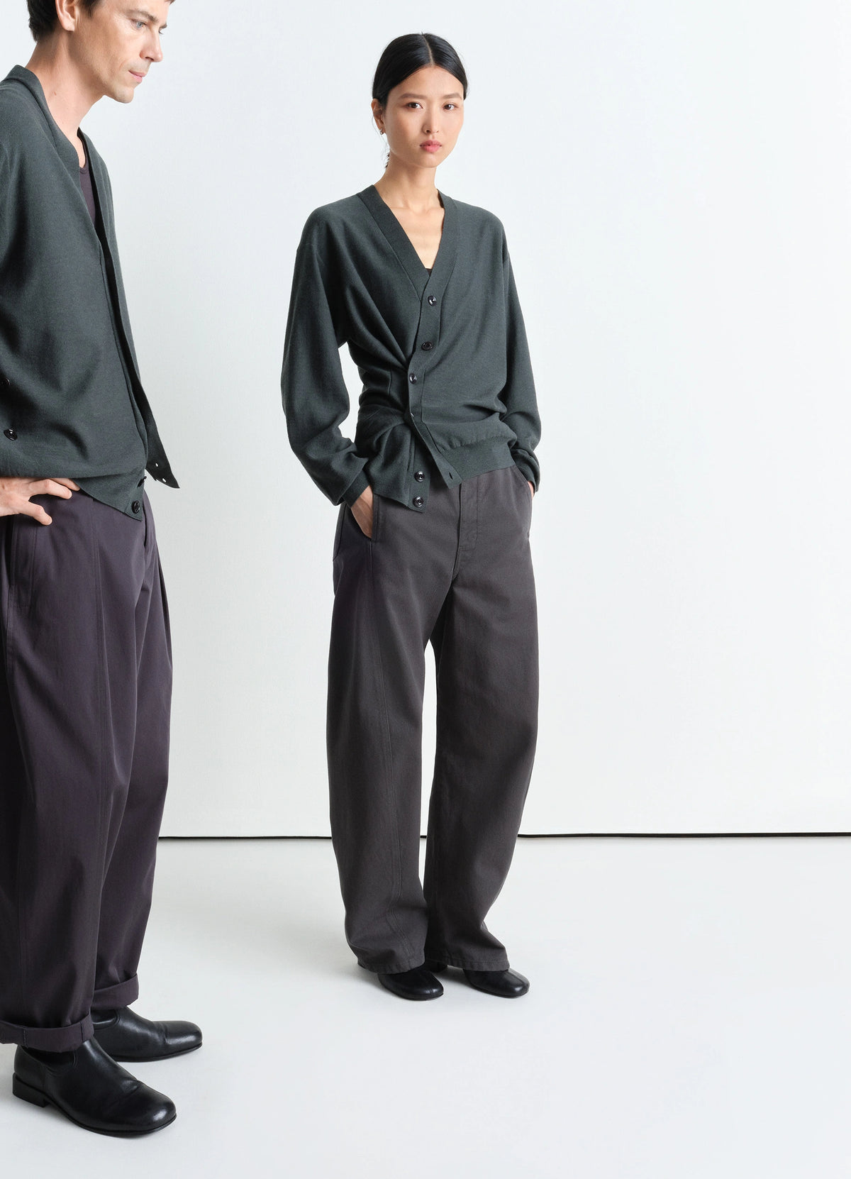 Lemaire Relaxed Twisted Cardigan in Merino Wool Blend, model shot, 3/4 front view Asymmetric button placket